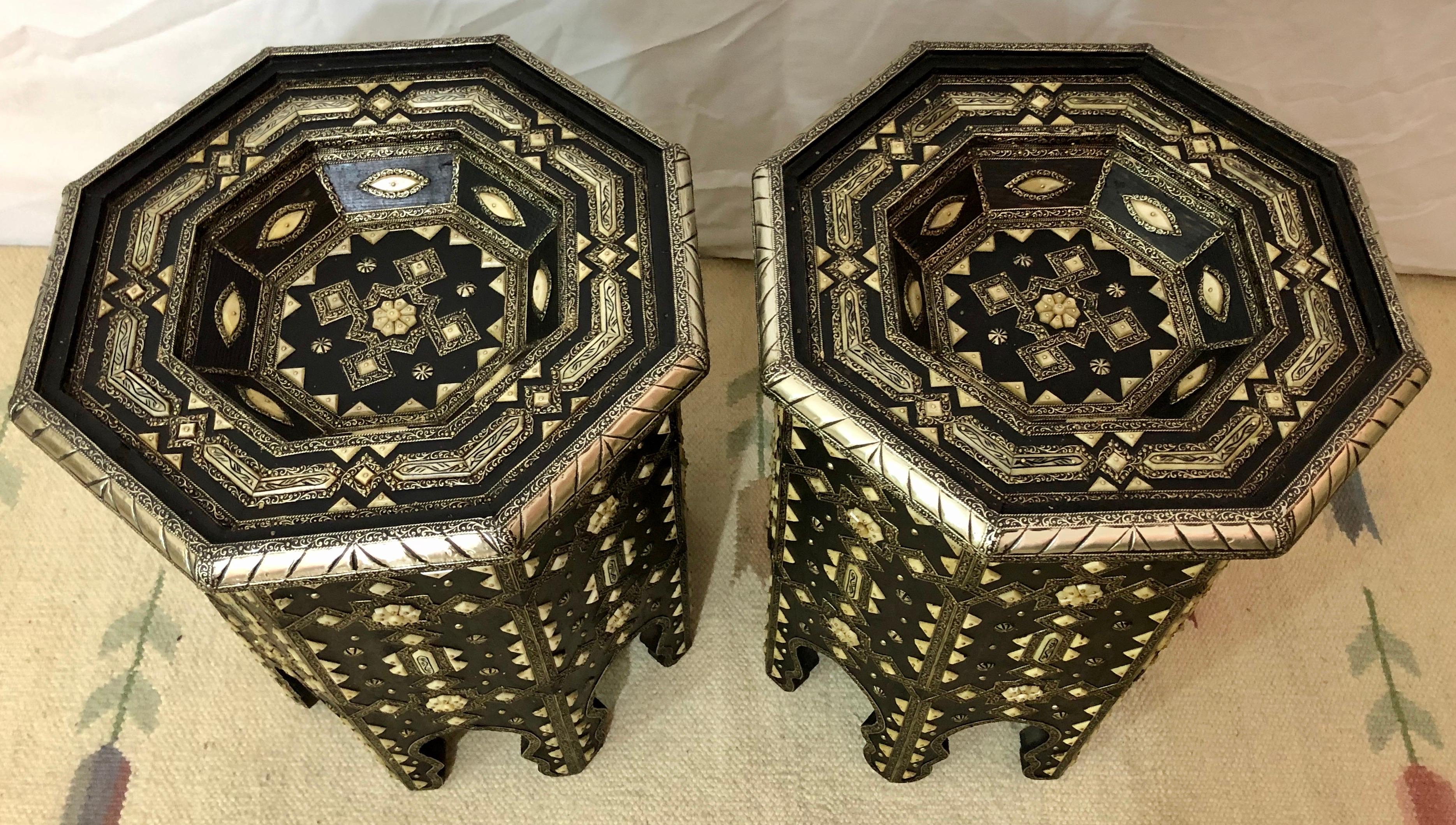 This luxurious wooden and brass table is an exotic and sophisticated addition to any room. Featuring a dazzling geometric pattern with white natural camel bone and brass inlay, black and white color combinations and a beautifully realized Moorish