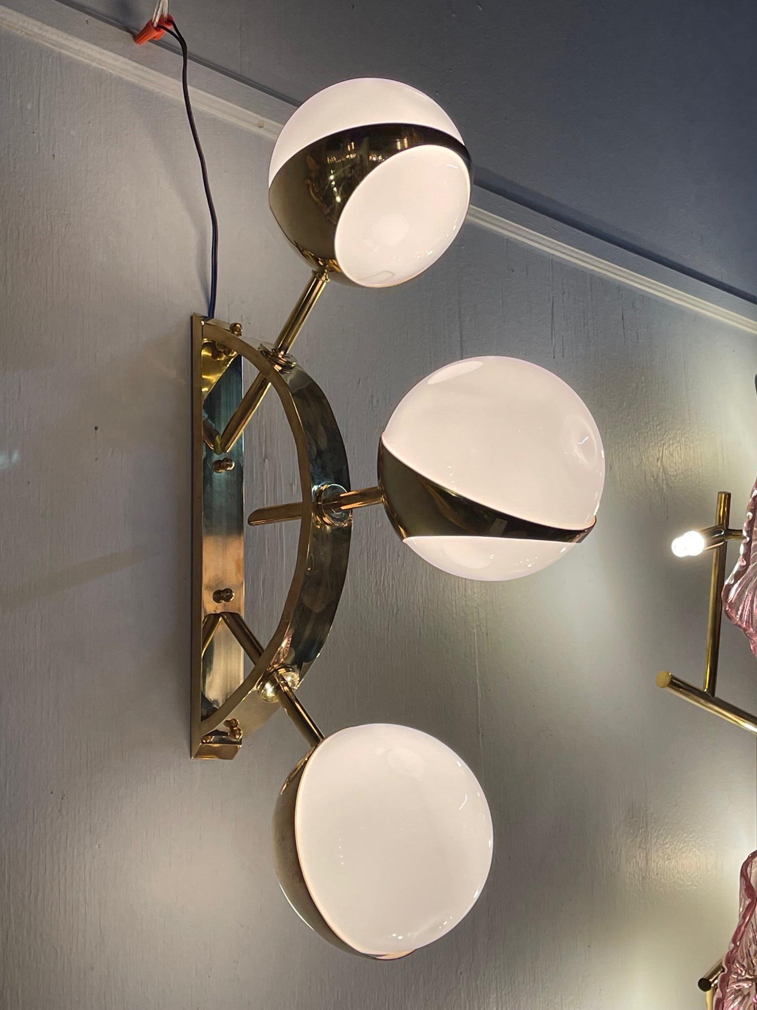 Gorgeous pair of modern Italian murano brass and ball form sconces. Makes a stylish statement!