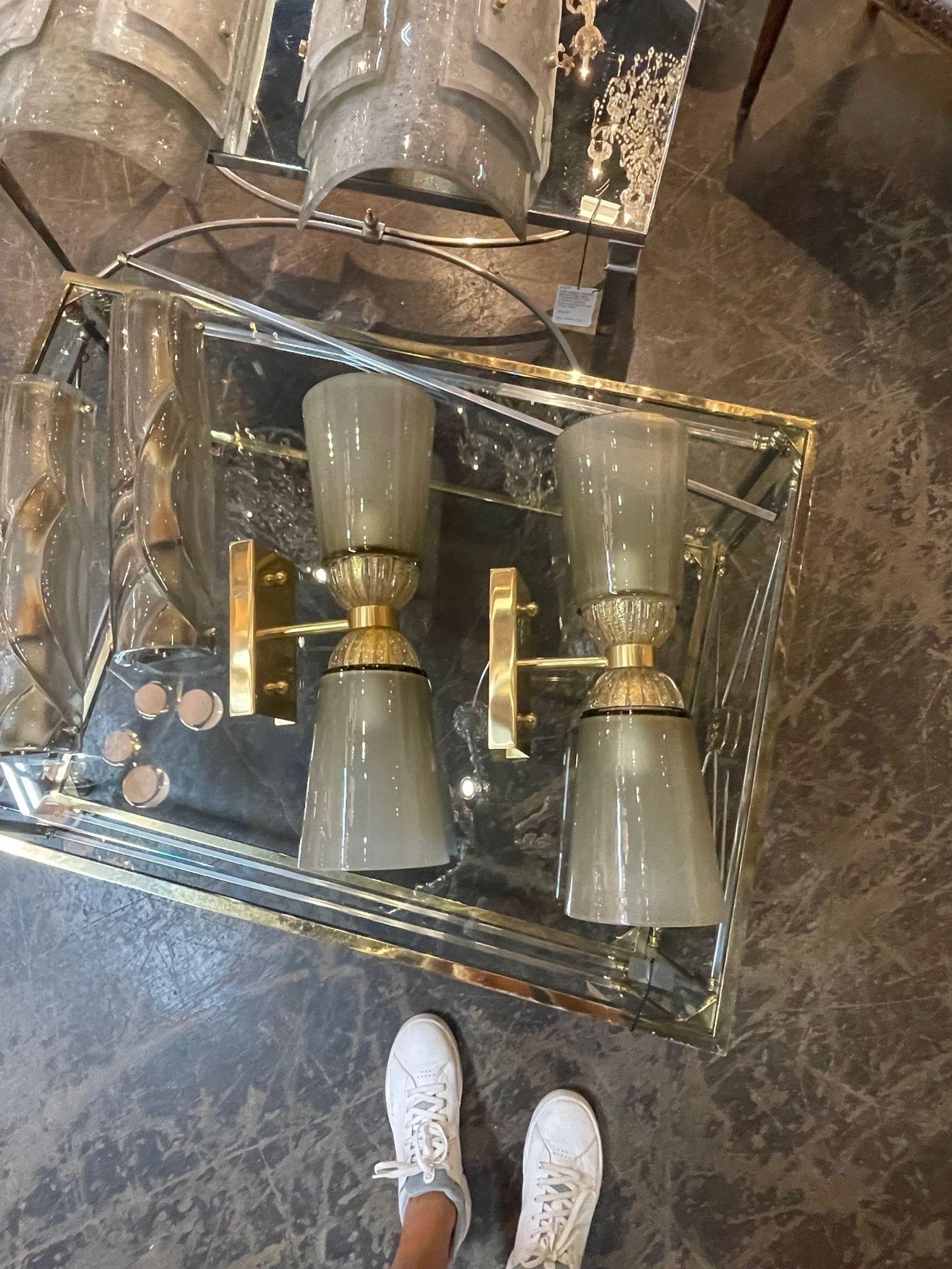 Lovely pair of modern Murano glass and brass double blown sconces. Very pretty cone shape with beautiful translucent and gold glass. So elegant!