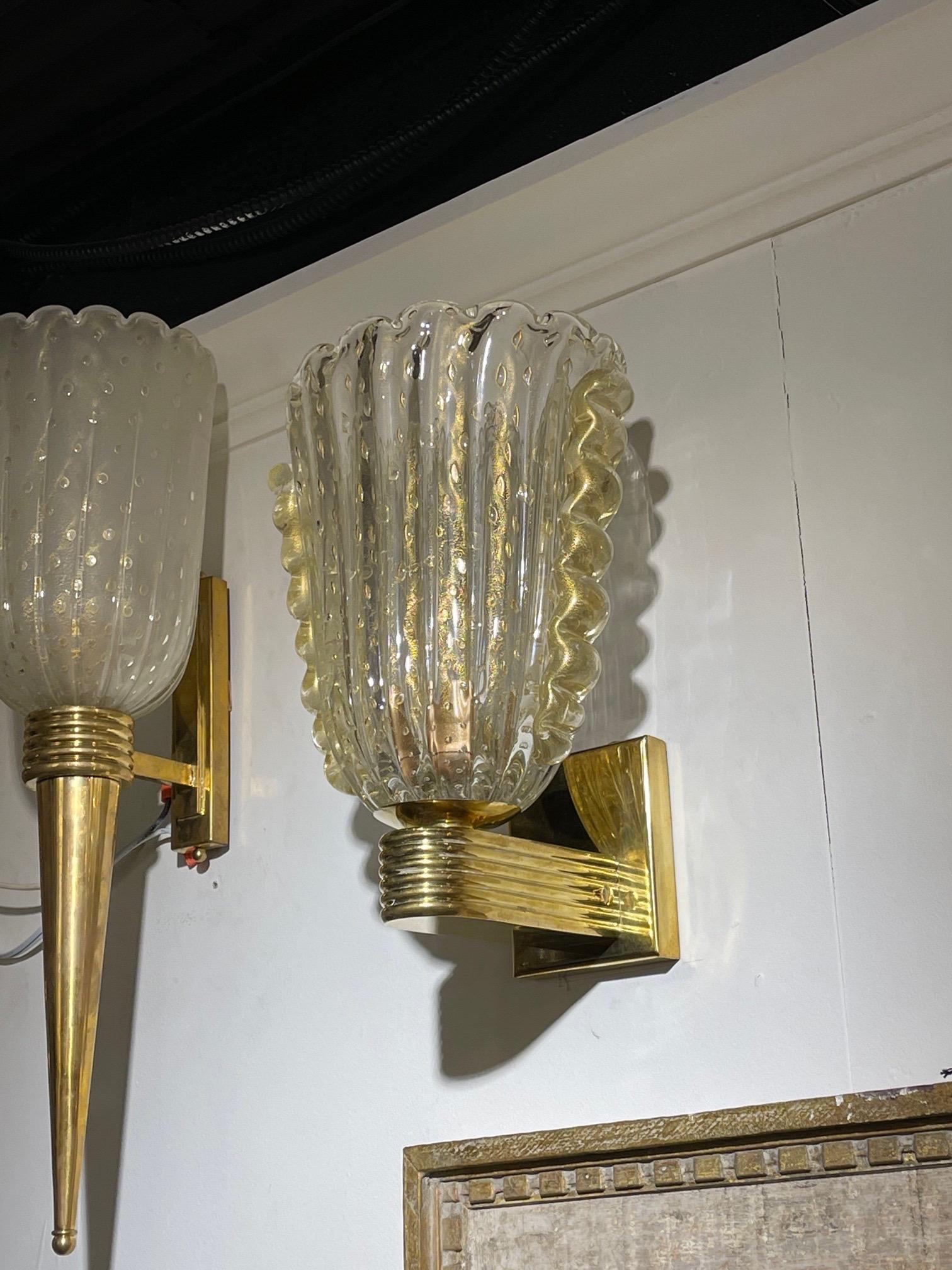 Fabulous pair of modern Murano glass and brass gold cup sconces. Beautiful flecks of gold throughout the glass along with a high quality base. Creates a very polished look!