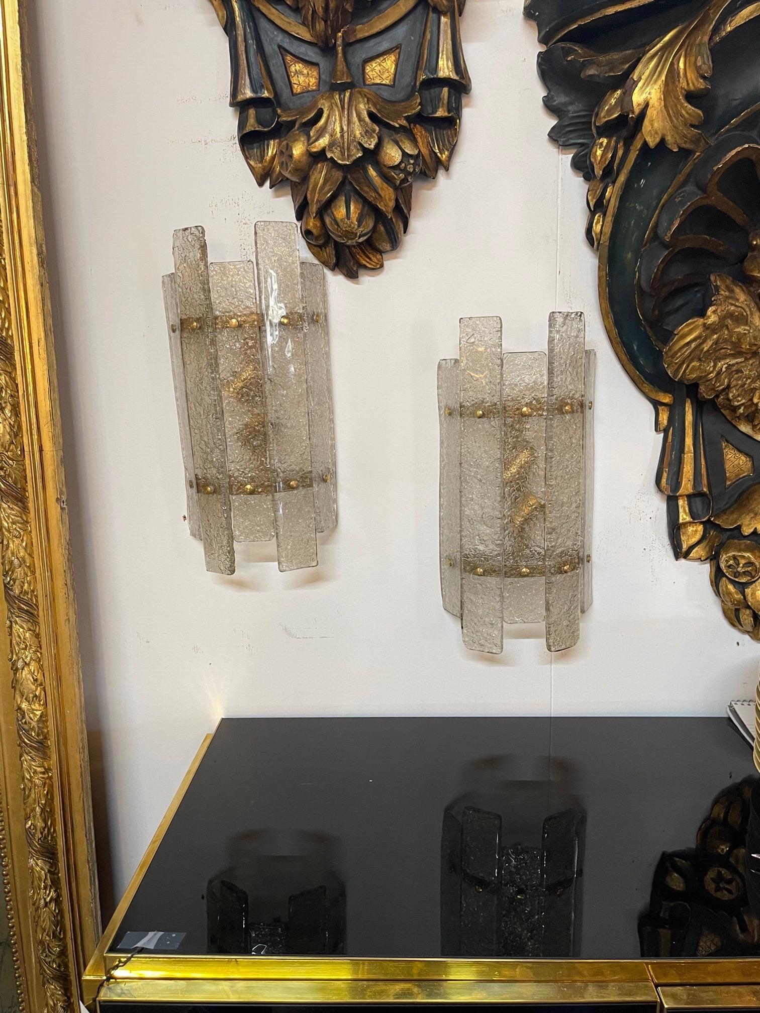 Stylish pair of modern Murano glass and brass sconces. Beautiful textured glass in varying lengths. Creates a lovely decorative look!