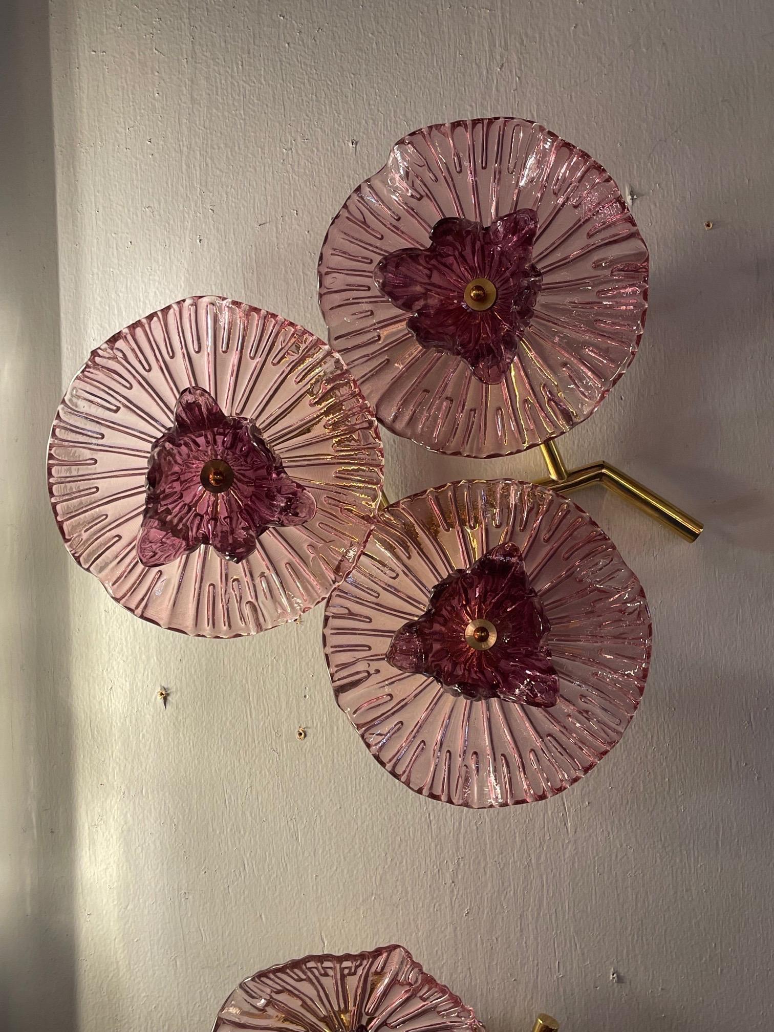 Decorative pair of lavender colored murano glass and brass sconces. Featuring beautiful glass that looks like flowers. Super pretty!!