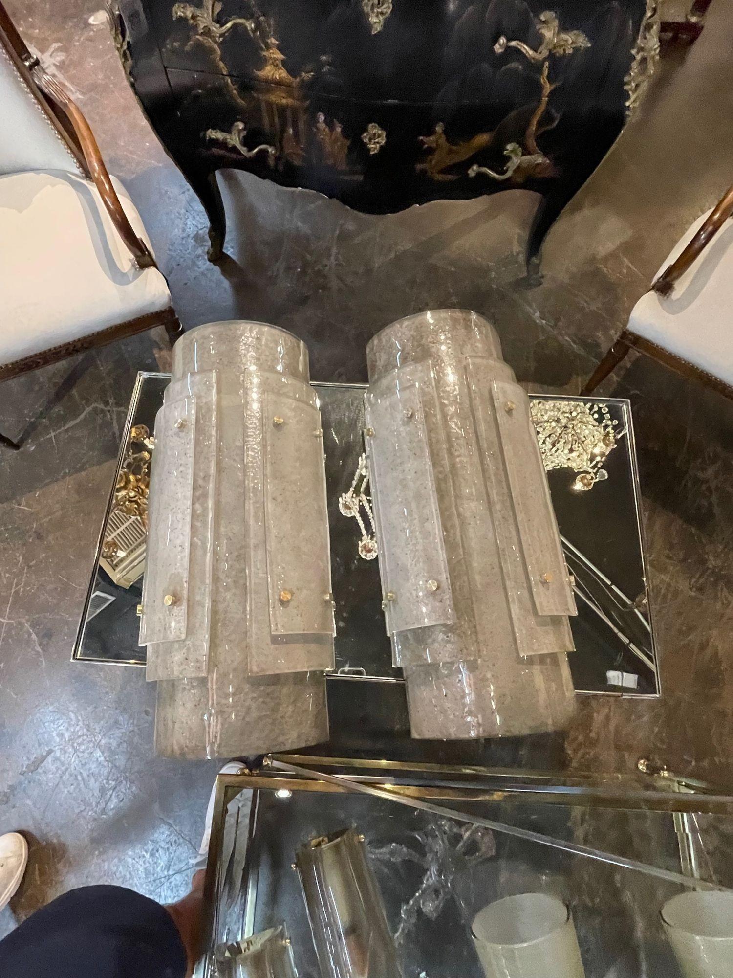 Decorative pair of modern large scale smoke glass Murano sconces. Featuring beautiful shimmering glass in layers. A favorite of top designers!