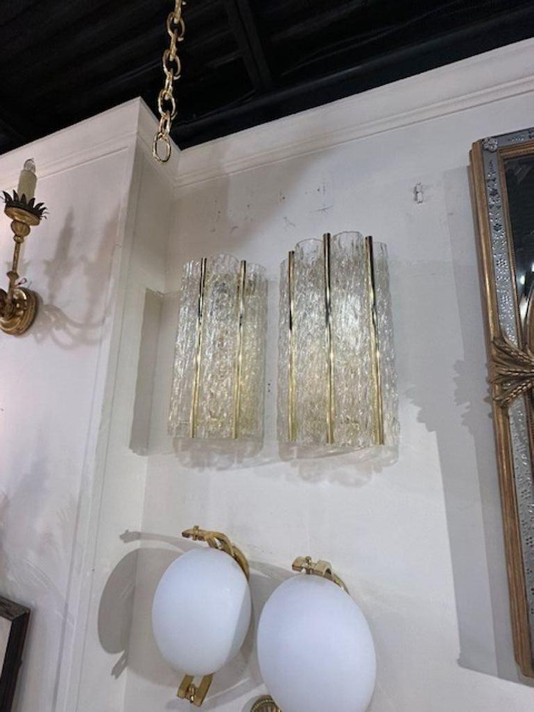 Gorgeous pair of modern Murano wave tube glass sconces with pretty polished brass accents. Makes a stylish statement.