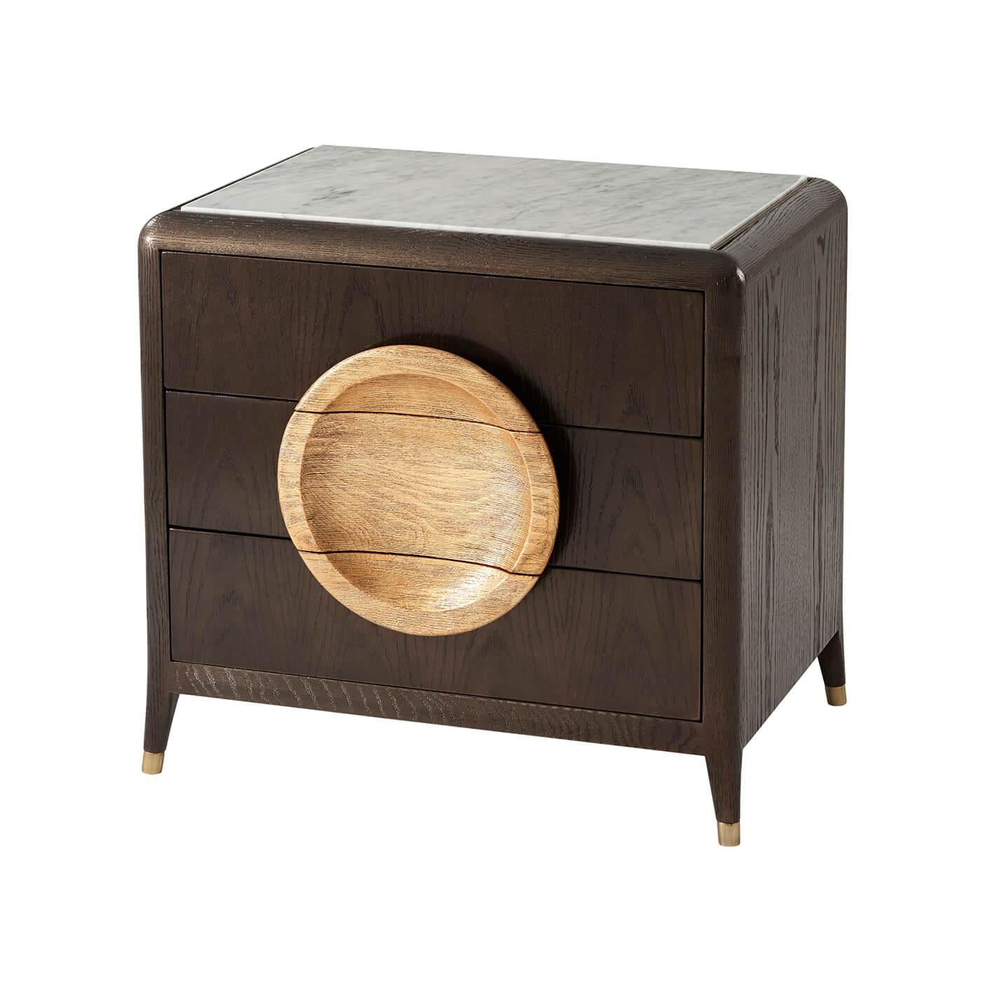 Modern oak and brushed crown oak veneered nightstands with a bronze finish, an inset Bianco Carrara marble top and three drawers with bold brushed oak gallery handles, raised on splayed turned and tapered legs with brass finish caps.

Dimensions: