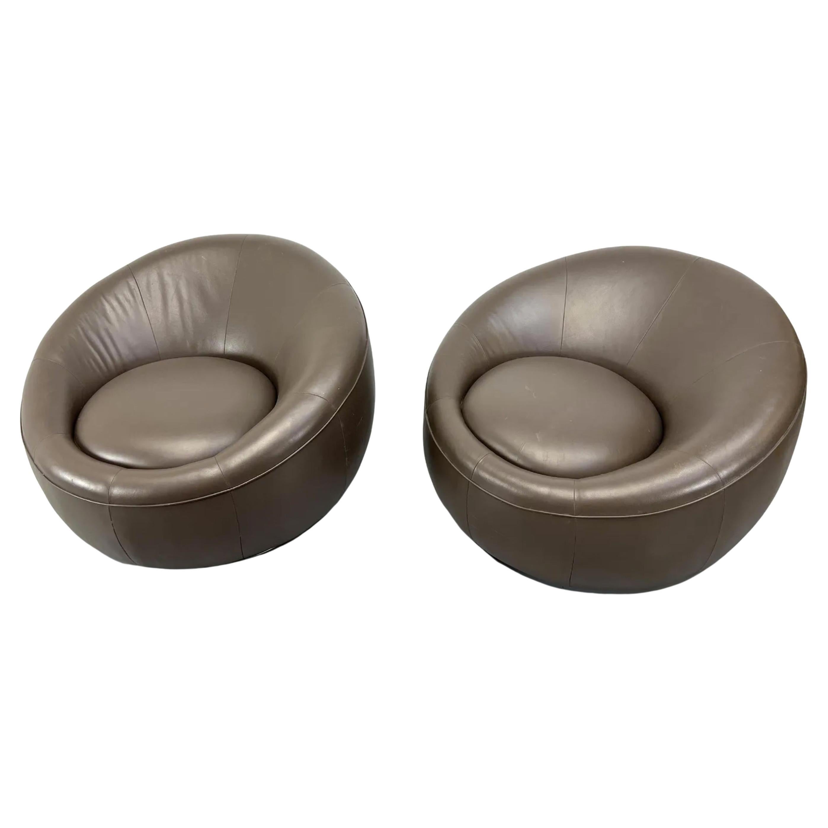 Pair of Modern Orb Pod Biomorphic Brown Leather lounge chairs on Swivel Steel round bases Leather is in good pre owned condition. Both chairs Swivel smoothly. Very cool pair of round Lounge chairs. Ready for use, very heavy and sturdy. Located in