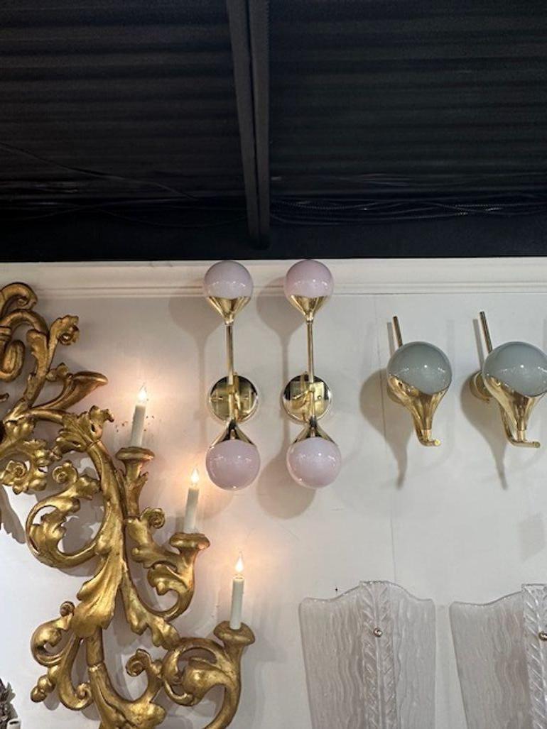 Decorative pair of modern pink pearl Murano glass sconces on a polished brass base. Very nice and can made in any color!