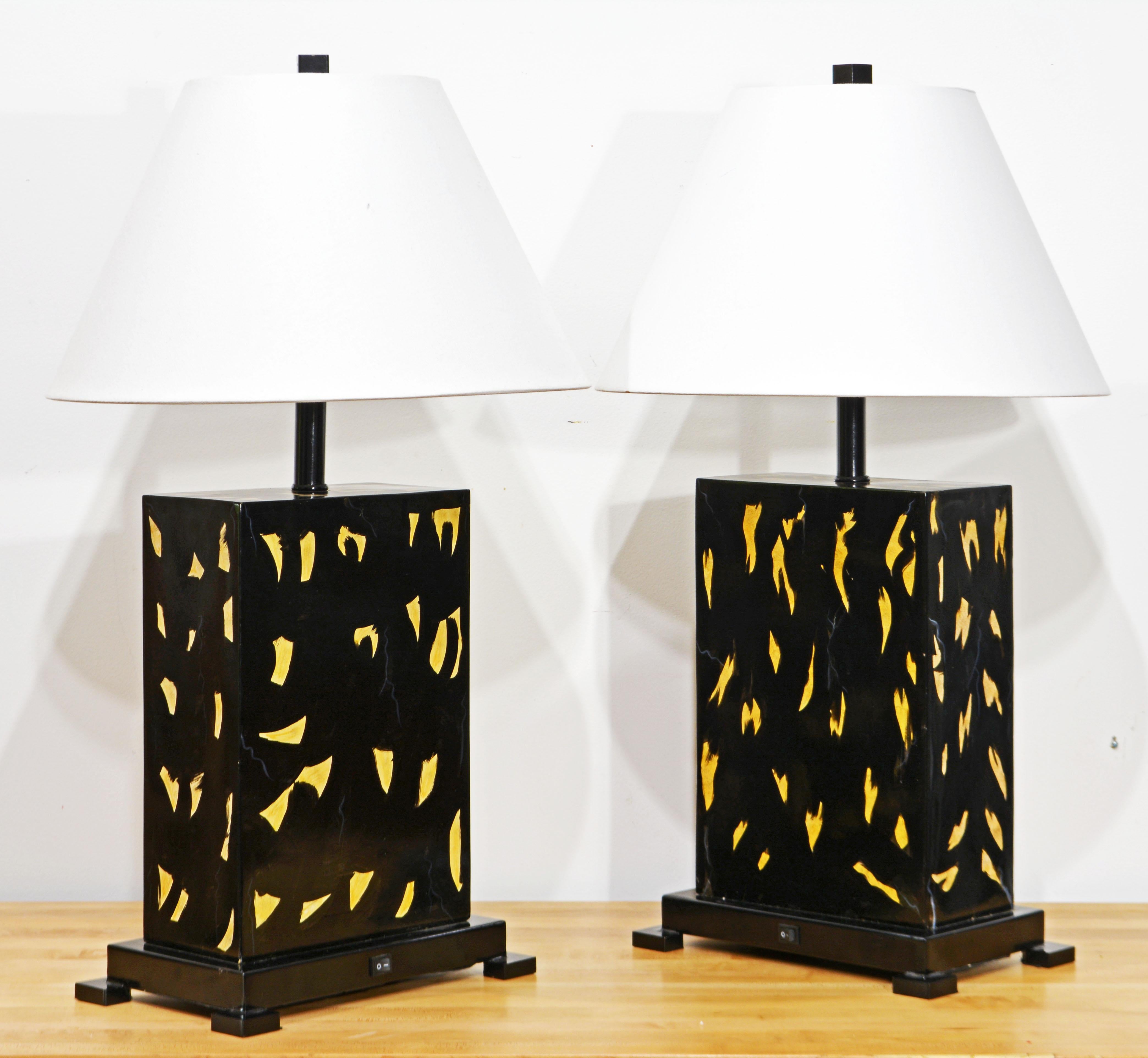These artistically accomplished table lamps feature a main rectangular body of heavy wood with blackered lacquered background and a expressive ivory colored fragments and subtle veins. Each lamp is slightly different reflecting the artist behind the