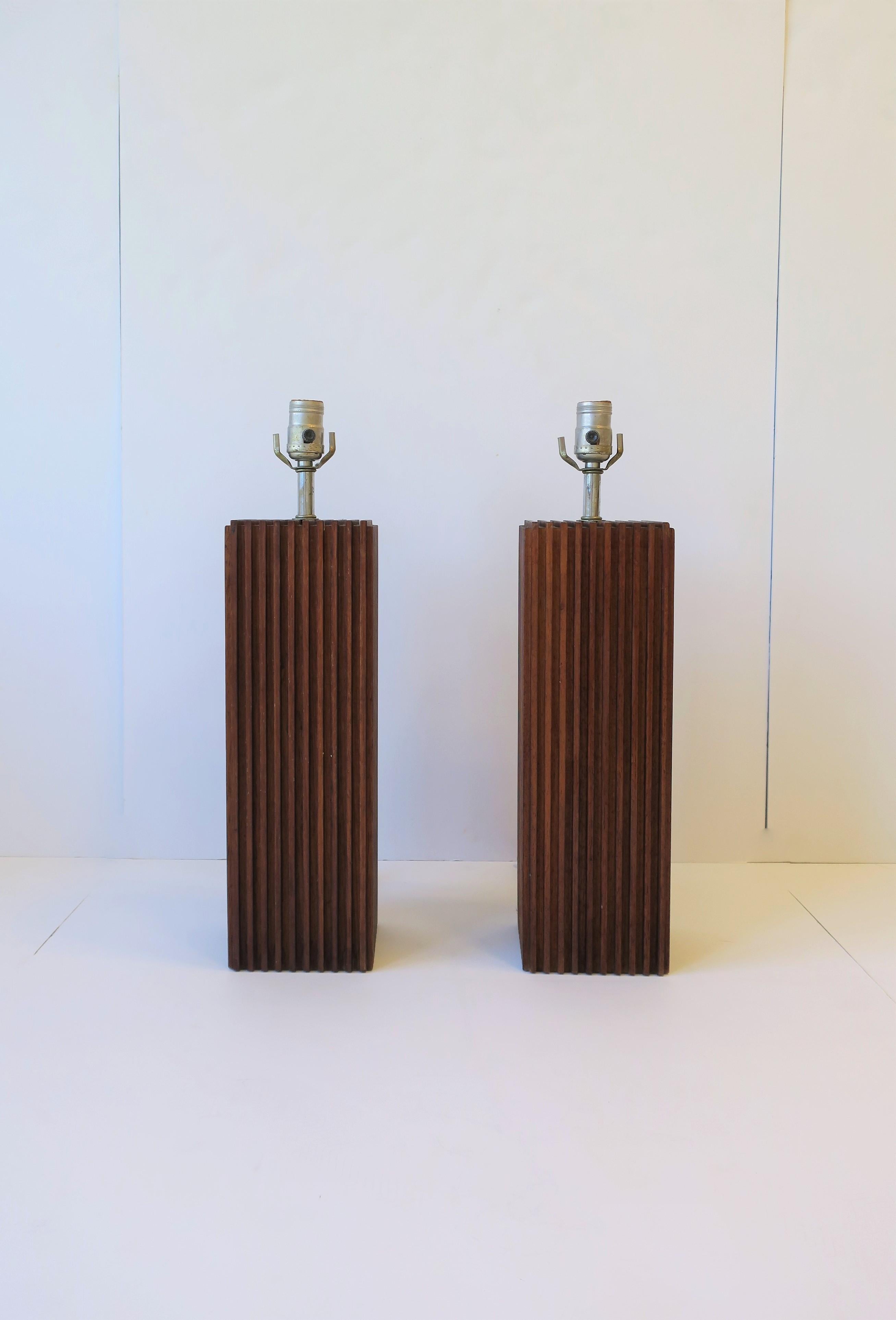 A very beautiful, substantial, and rich pair of 1970s Modern and Art Deco style wood table lamps with a vertical linear design, circa 1970s.

Measurements: 
21
