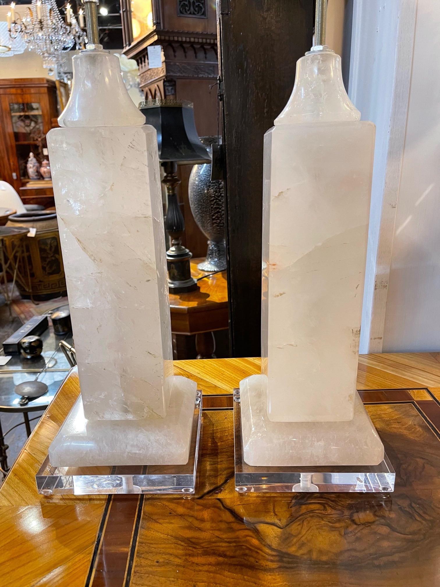 Elegant pair of modern rock crystal lamps on lucite bases. Very fine quality and so impressive!