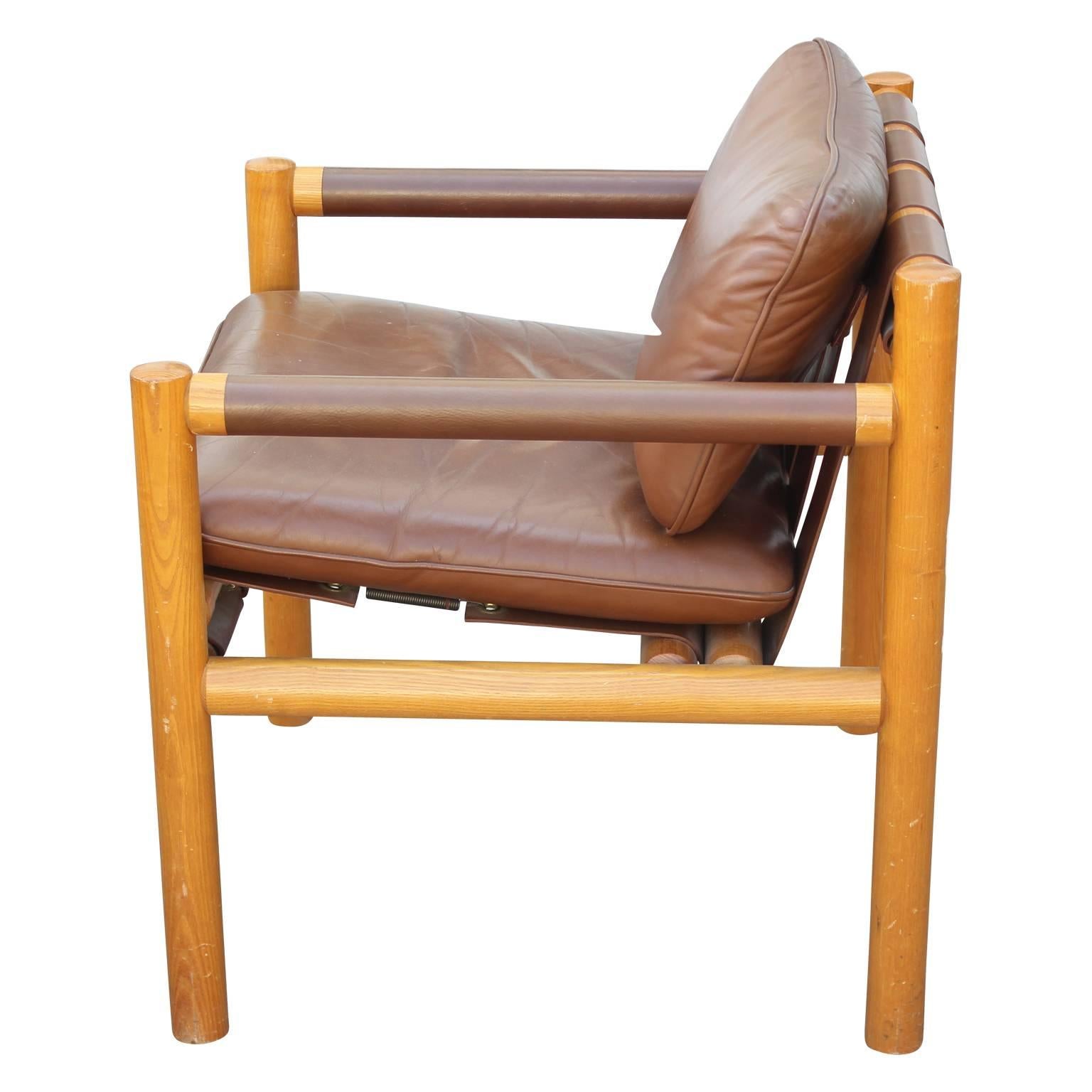 Pair of gorgeous Scandinavian / Danish safari lounge chairs made from gorgeous oakwood and brown leather with upholstered arms. Perfect addition to any space looking for a Mid-Century Modern relaxed touch. 

We have two sets available.
