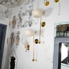 Pair of modern single-arm torch style sconces