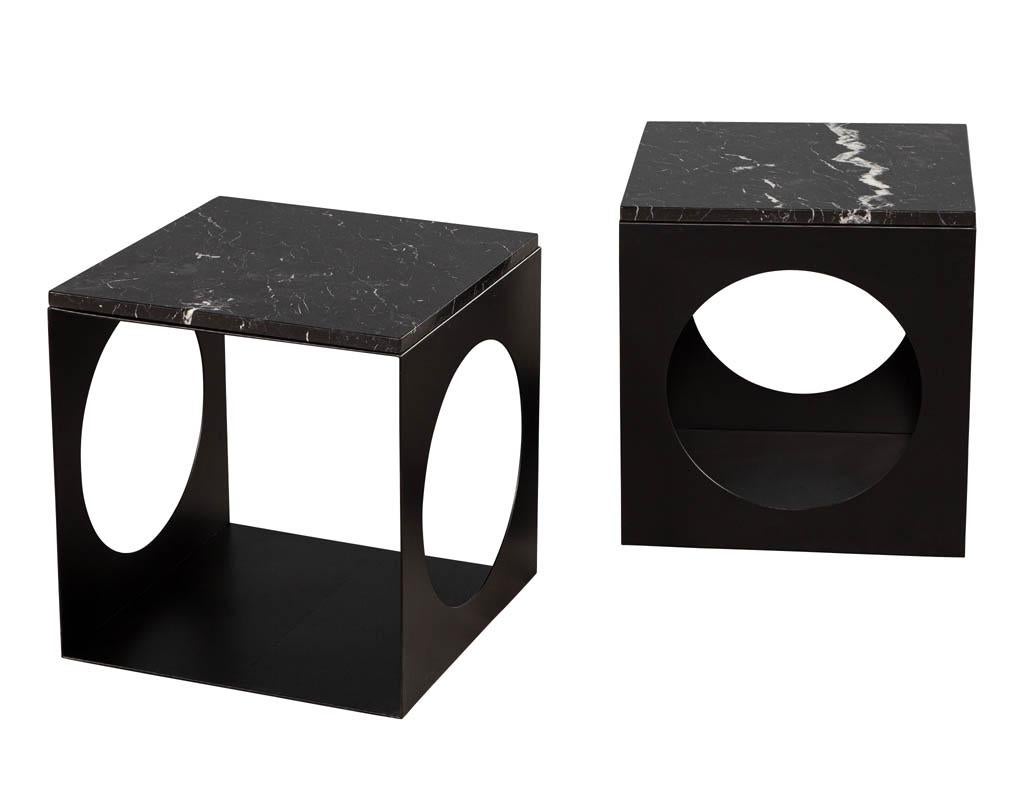 Pair of modern steel & marble side tables in the Style of Minotti. Sleek modern design with black powder coated metal. Featuring beautiful black and white marble tops.

Price includes complimentary scheduled curb side delivery service to the