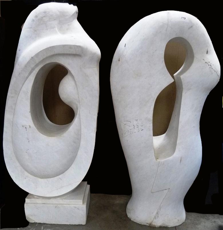 Striking monumental pair of Modern style abstract sculpture statues. The monolithic piece of white marble was chiseled and polished to a fairly shiny gloss. 
One statue depicting an arched nude female with her neck extended looking upwards. 
Second