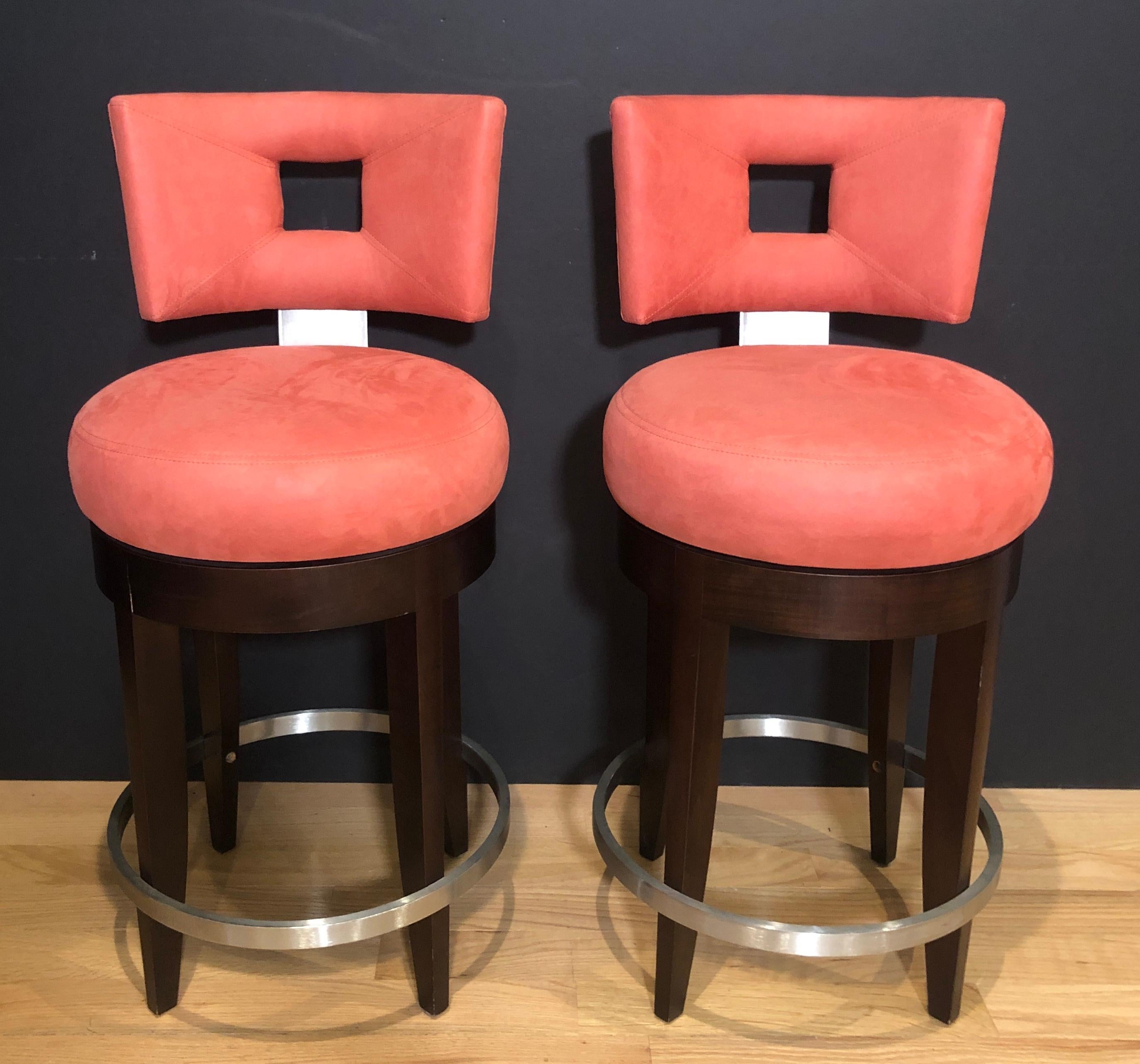 Pair of high back Odeon modern counter height stools by Evanson Studios New York. Beautifully upholstered, swivel with foot rest in contrasting brushed stainless steel.