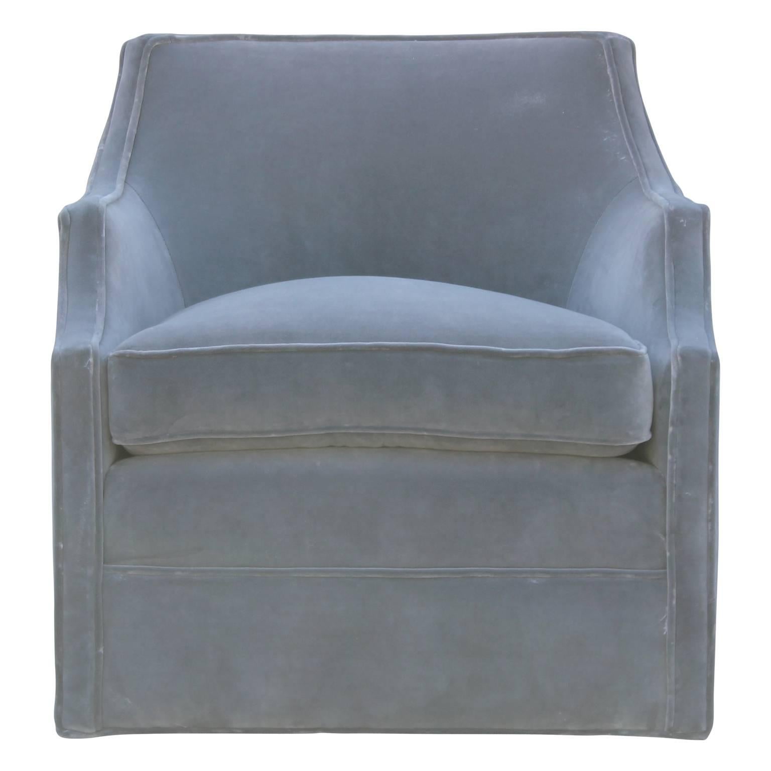 Luxe pair of modern swivel armchairs in the style of Baker Furniture and freshly upholstered in a lush grey velvet.

Measures: Seat height: 20 in.