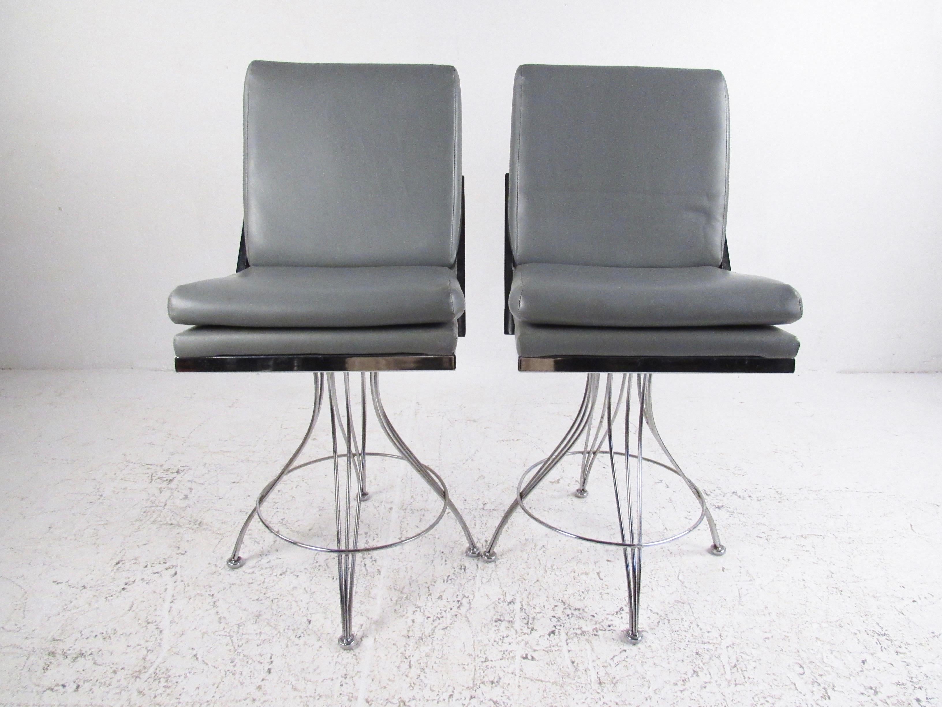 This stylish pair of contemporary modern stools features chrome finish swivel bases with comfortable upholstered seats. The sleek modern design of the matching pair makes a striking addition to home or business counter seating. Measures: 28 inch