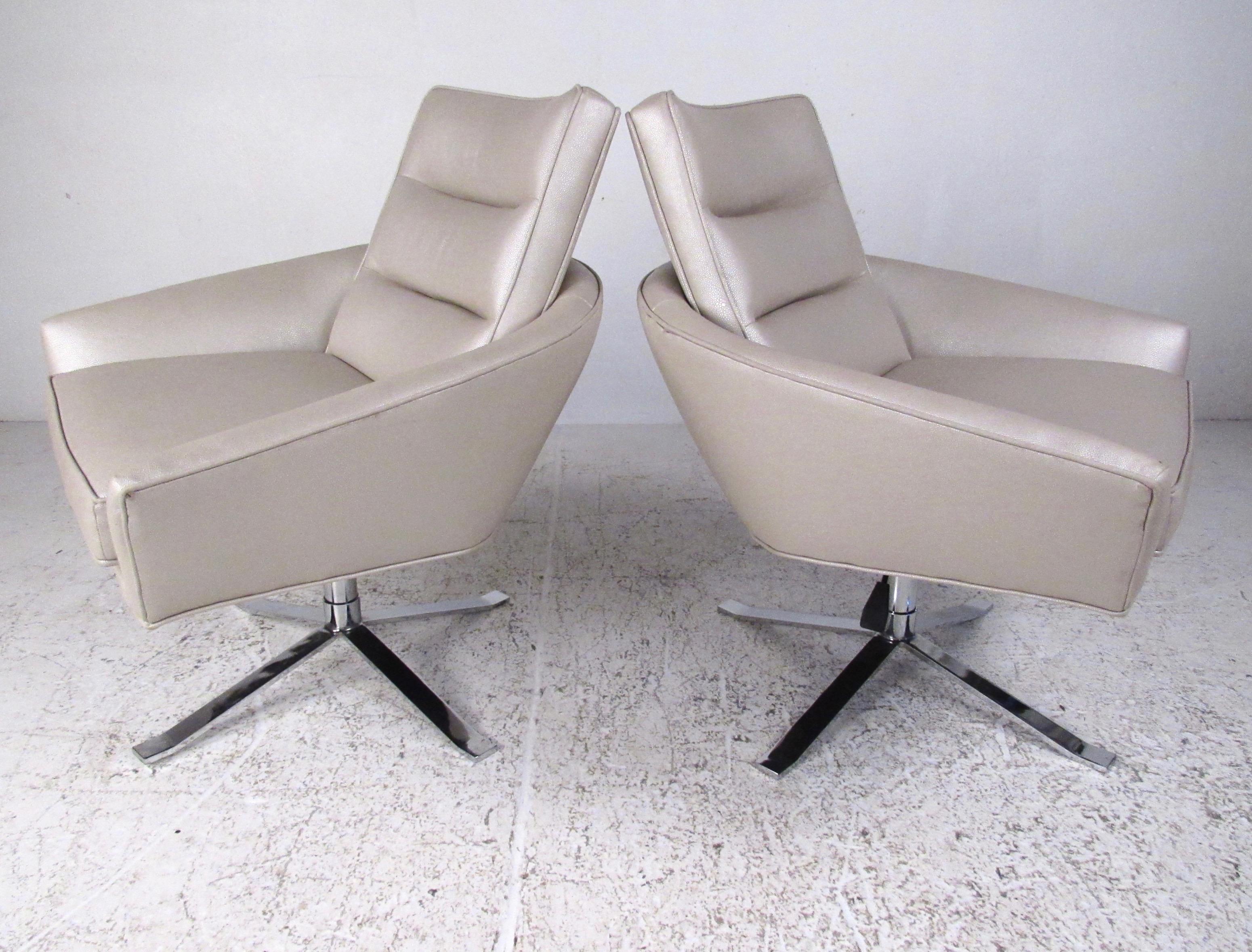 This stylish pair of modern lounge chairs feature heavy chrome frames and textured vinyl upholstery. Comfortable proportions and adjustable seat height (from 18.5-21 inches) add to the versatility of this unique pair. Striking set of swivel lounge