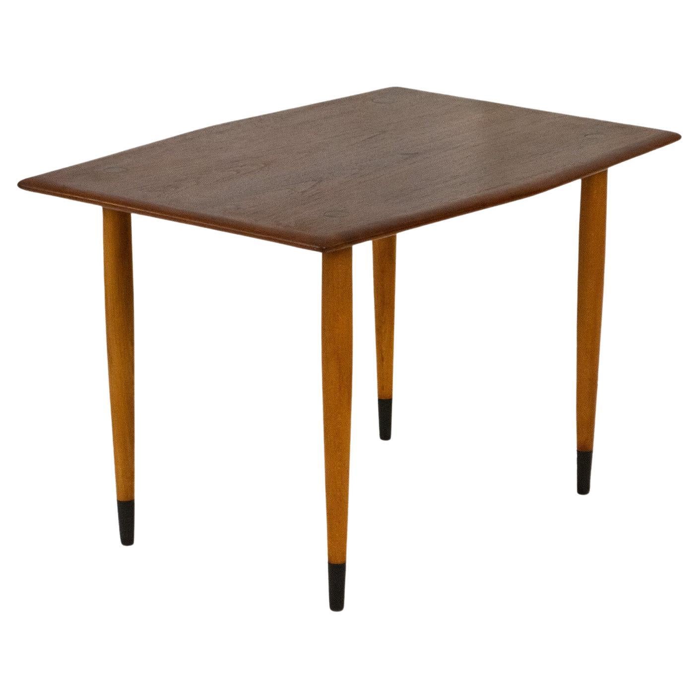 Everything about this pair of Modern Teak and Brass side tables by Dux of Sweden is subtle, delicate, and stylish. The table top has a beautiful teak wood grain and is designed in a unique hexagon shape with soft curving edges. It features lovely