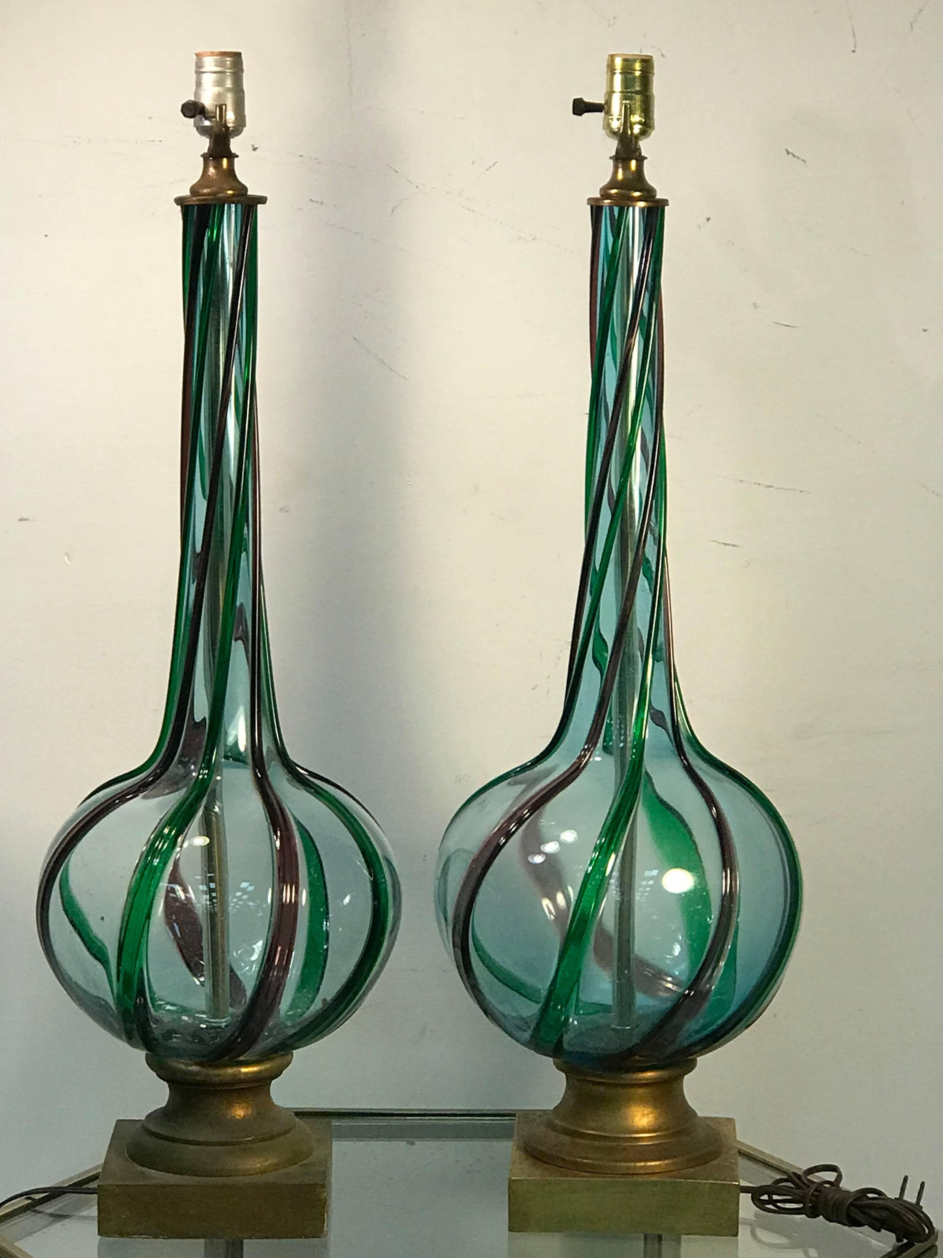 Great pair of modernist light aqua Murano lamps with applied green and purple swirled stripes, mounted on a giltwood base. Designed in the 1950s-1960s in Italy by Cenedese. Measurements of glass body alone are 24