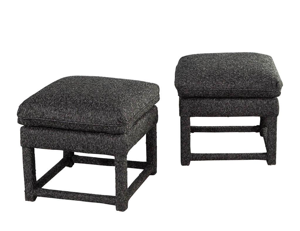 Pair of Modern upholstered stools. Featuring fully upholstered design in a textured charcoal colored fabric. Clean sleek lines with thick top cushion. The perfect pair to complete a space. Price includes complimentary curb side delivery to the