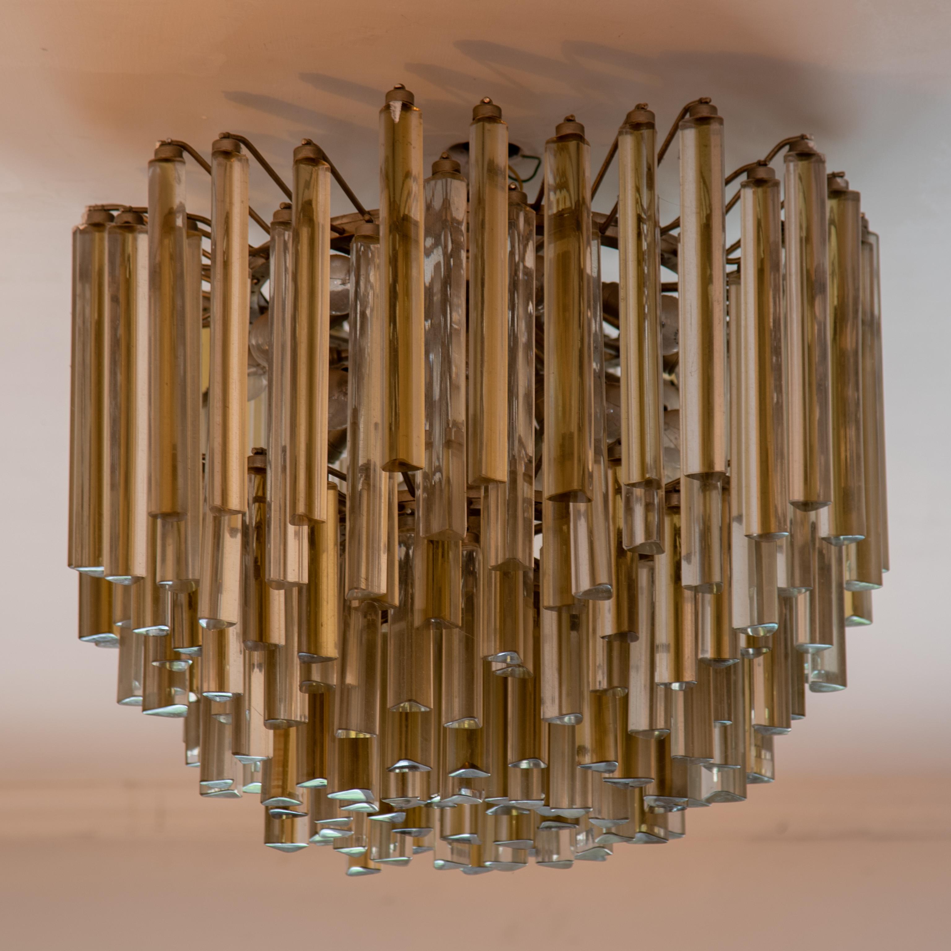 Pair of unique shape original 1970s Italian chandelier by Paolo Venini Murano Italy
Each chandelier features 172 two-colors gold and clear crystals descending stacked layers of triedri prisms
and hanging from hooks onto a chrome frame, 8 rows and 21