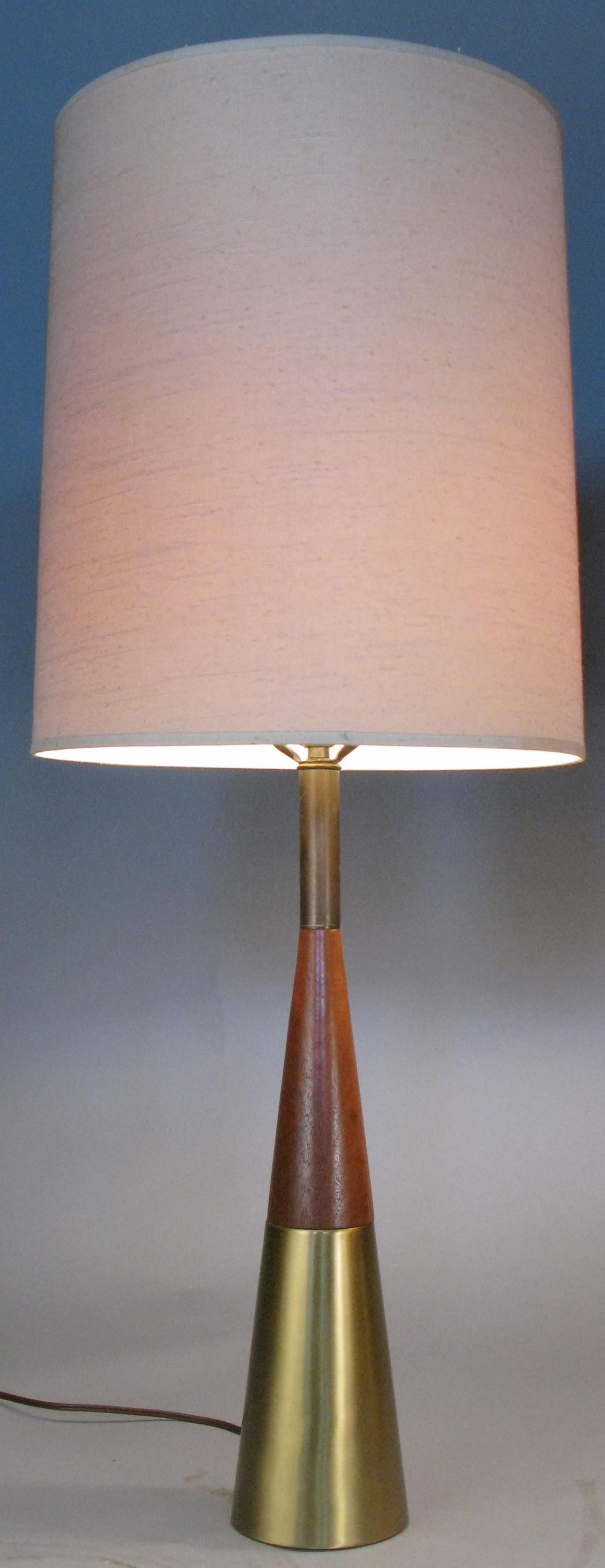 A stunning matched pair of 1950s table lamps designed by Tony Paul. with bases of brushed brass and beautifully figured walnut, these are among the most elegant of Paul's lamp designs from the mid 20th century. Beautiful tapered form and with their
