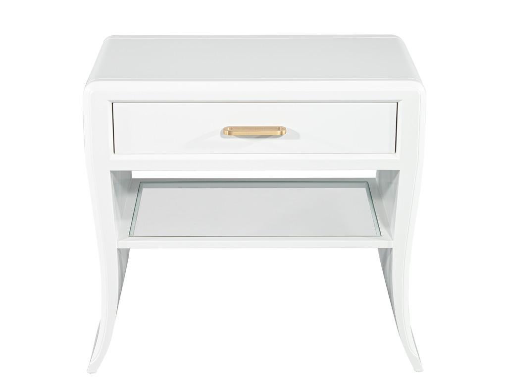 Introducing our stunning pair of modern white curved nightstand end tables, where contemporary elegance meets functional design. Crafted with a unique curved silhouette, these nightstands serve as a delightful focal point in any bedroom,