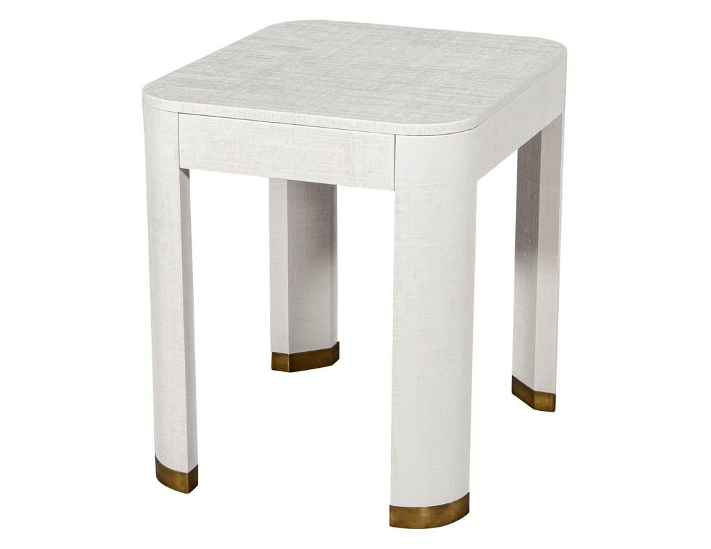 Pair of modern white linen clad side tables. Featuring clean modern design and brass capped feet.

Price includes complimentary scheduled curb side delivery service to the continental USA.