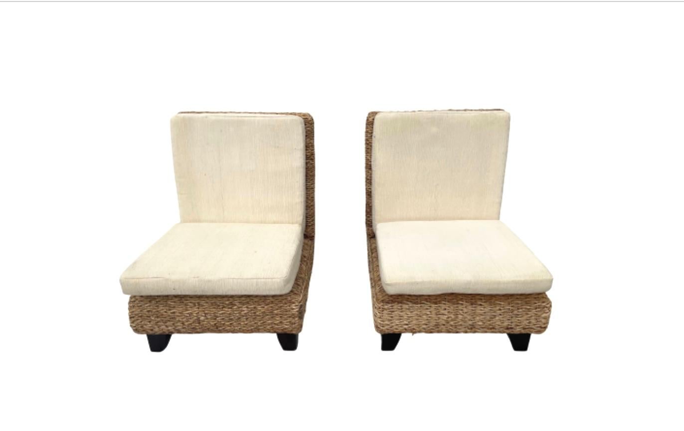 Pair of excellent wicker slipper chairs with thick cream colored back and seat cushions(included) and four short sturdy feet. Perfect for beach or coastal decor.