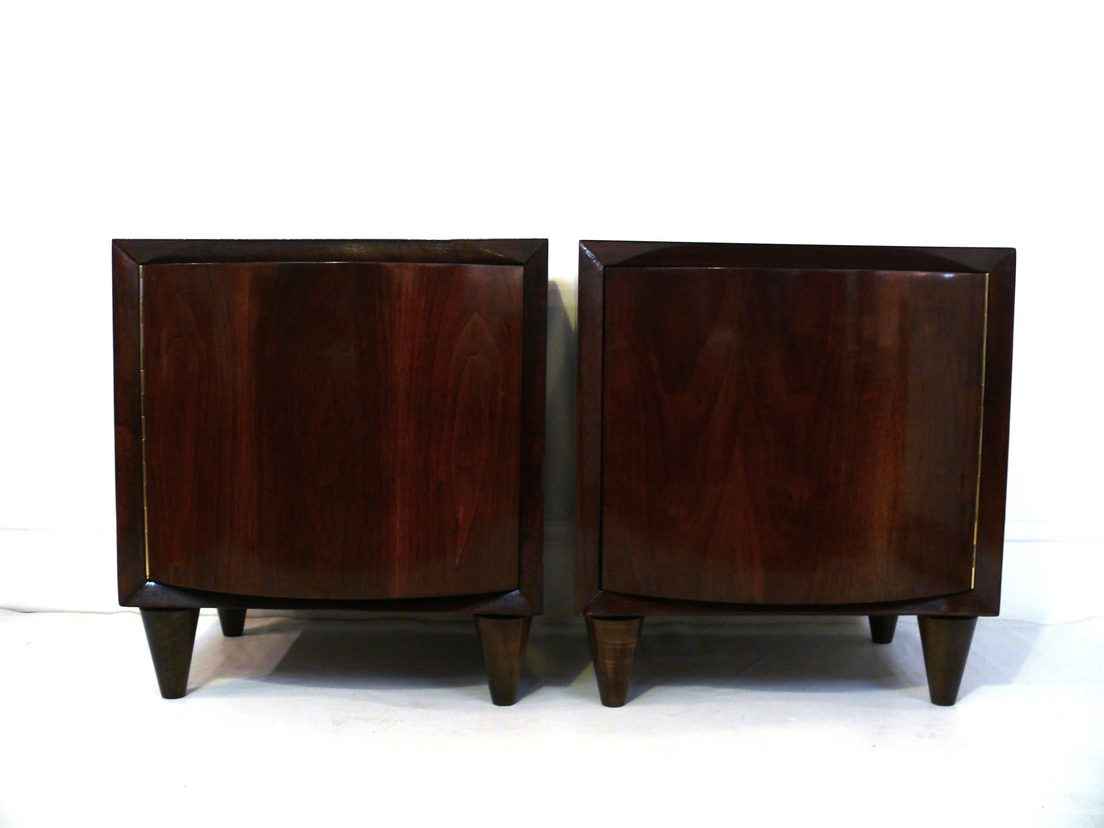 Pair of Modernage walnut bow front end tables. Great curved lines with single door.