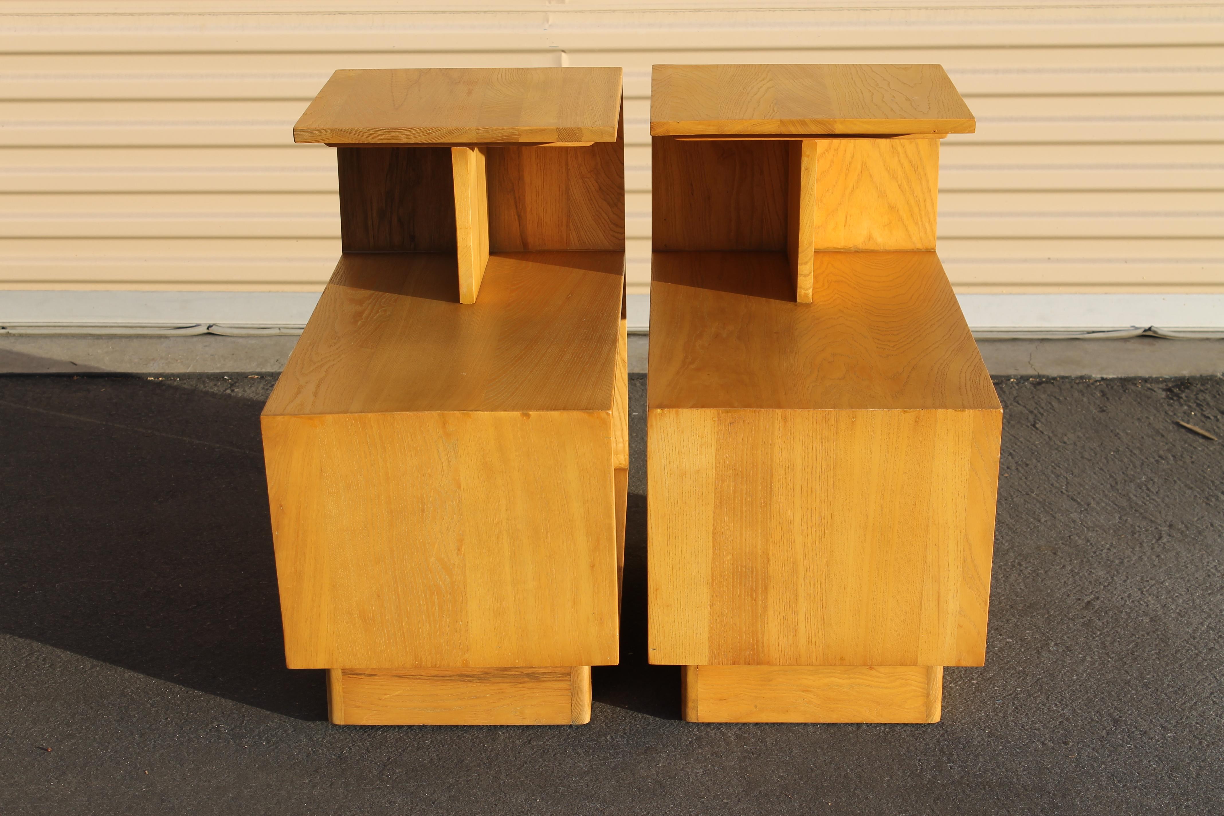 Pair of streamline moderne oak end tables. These were originally painted black. We had them refinished back to their wonderful oak finish. Measures: Tables are 15