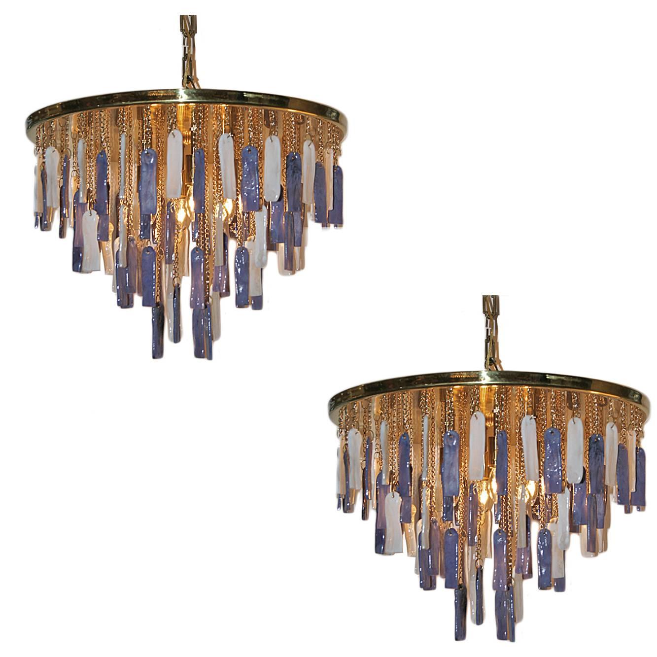 A pair of circa 1960's Italian ceiling fixtures with white and amethyst art glass pendants on brass chain. Sold individually.

Measurements:
Diameter: 23