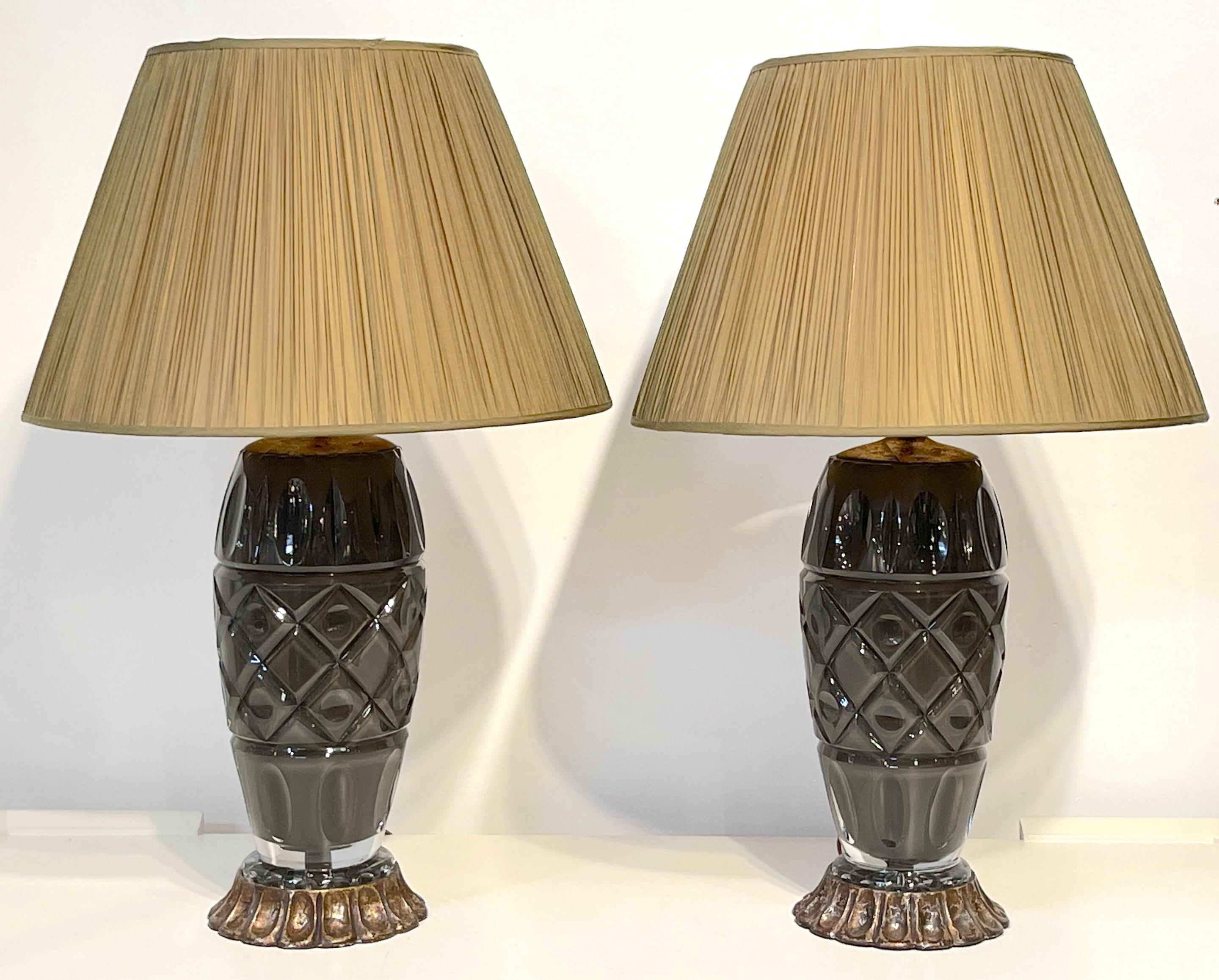 Pair of Moderne Maison Baguès Style Taupe Cut Crystal Lamps 
France, circa 1960s

A sheik pair of Maison Baguès cut taupe crystal vases, raised on carved wood silver leaf bases. Shown with display shades not included. 
Ready to place and shade.