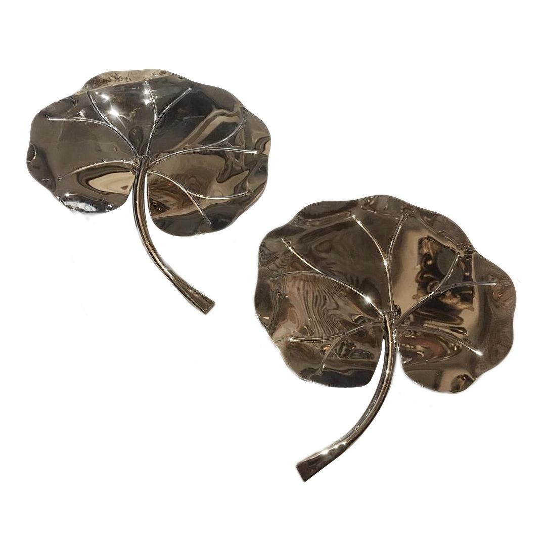 A pair of circa 1950s French nickel-plated sconces depicting large tropical foliage.

Measurements:
Height 12