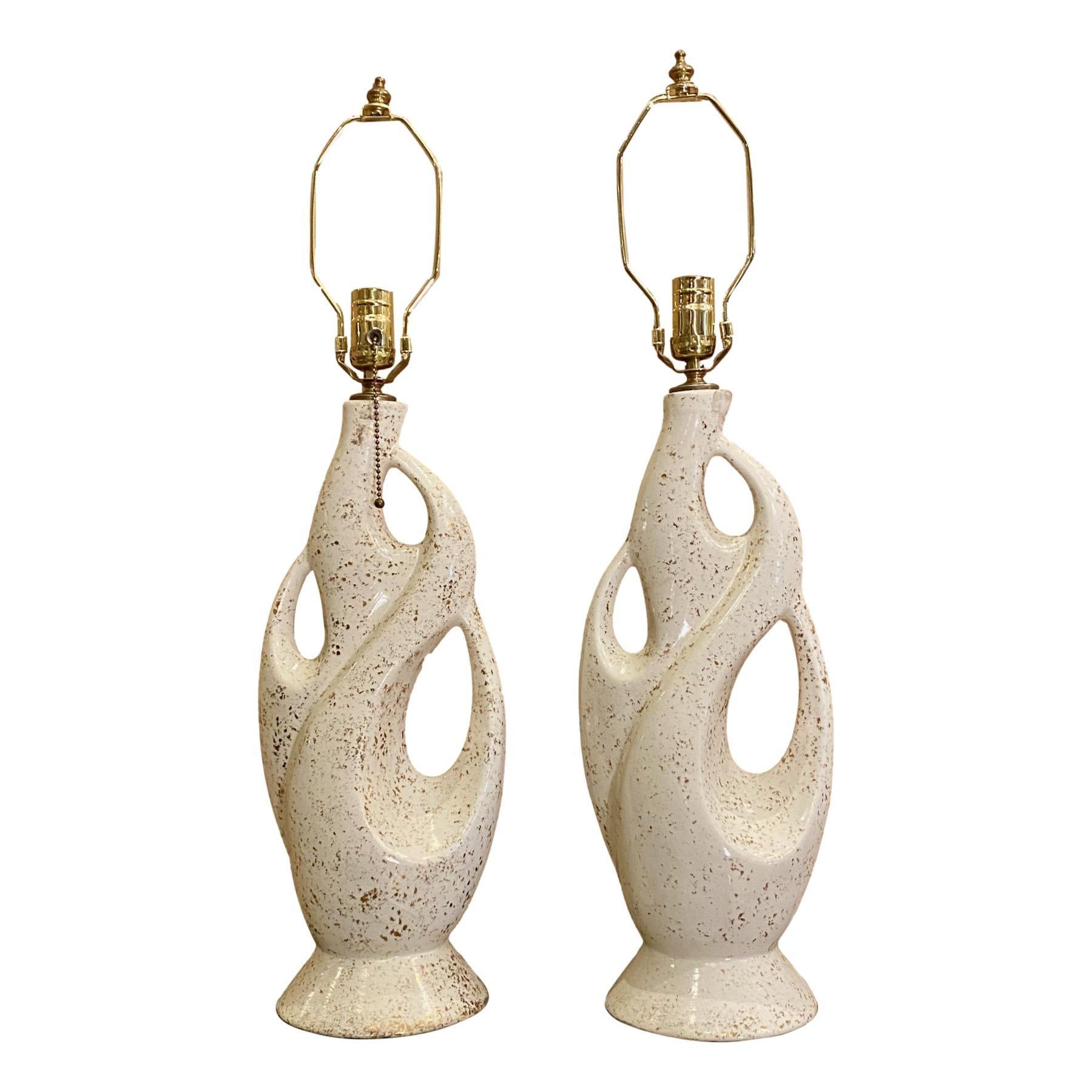 Pair of circa 1960’s Italian moderne style white porcelain lamps with gilt details.

Measurements:
Height of body: 19?
Height to shade rest: 27?
Diameter at widest: 8