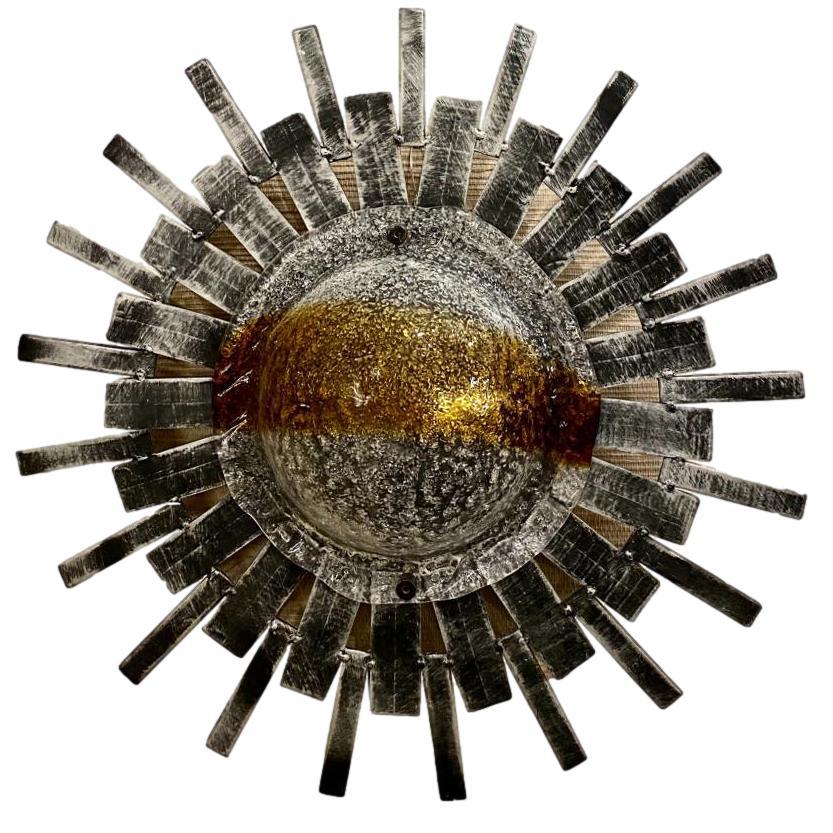 A circa 1960s Italian hammered iron and blown glass sunburst light fixture with glass inset. Can also be installed as sconces.

Measurements:
diameter: 18