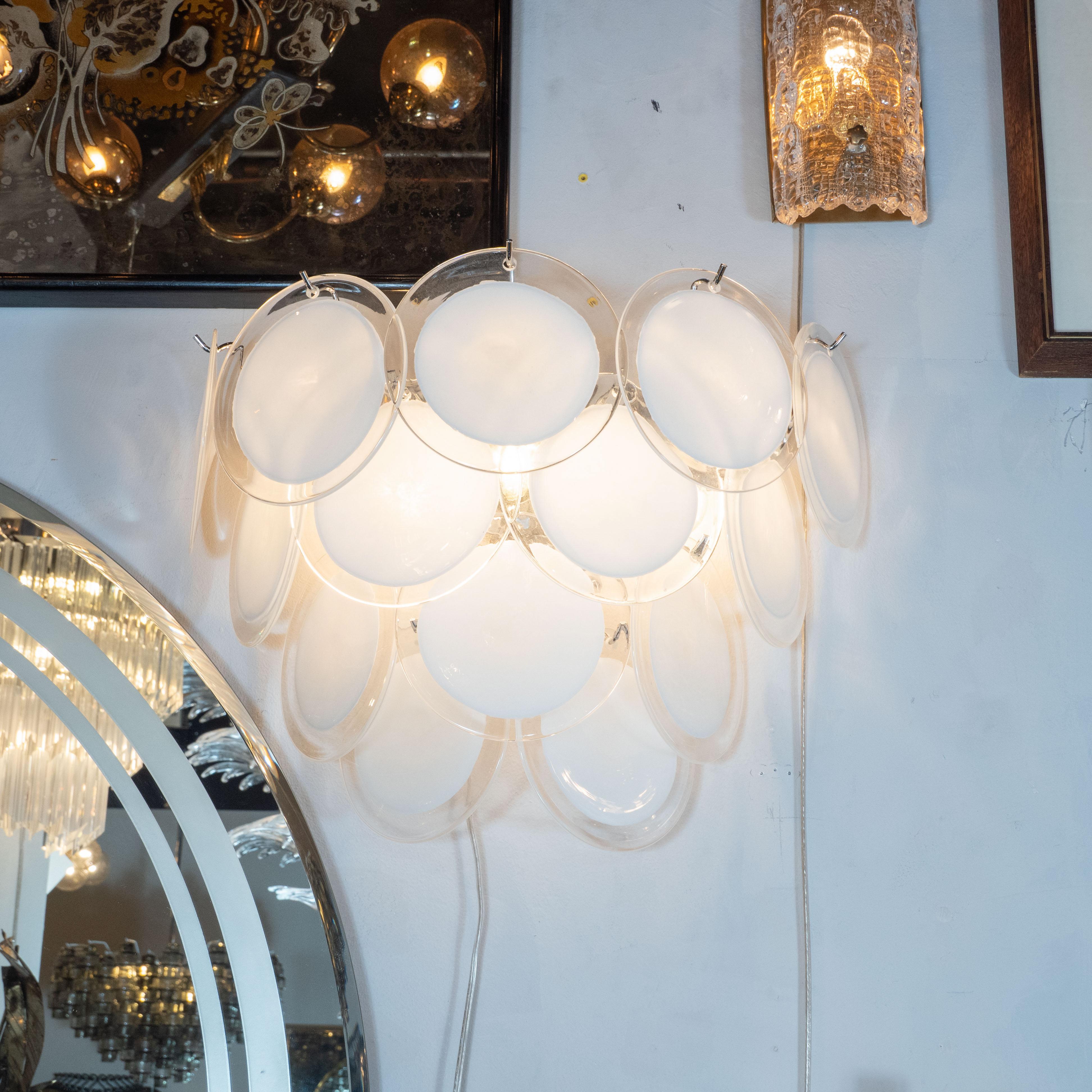 This beautiful pair of modernist 14-disc Vistosi sconces were made exclusively for high style deco by our atelier in Murano, Italy- the island off the coast of Venice, renowned for centuries for its superlative glass production. Realized in the