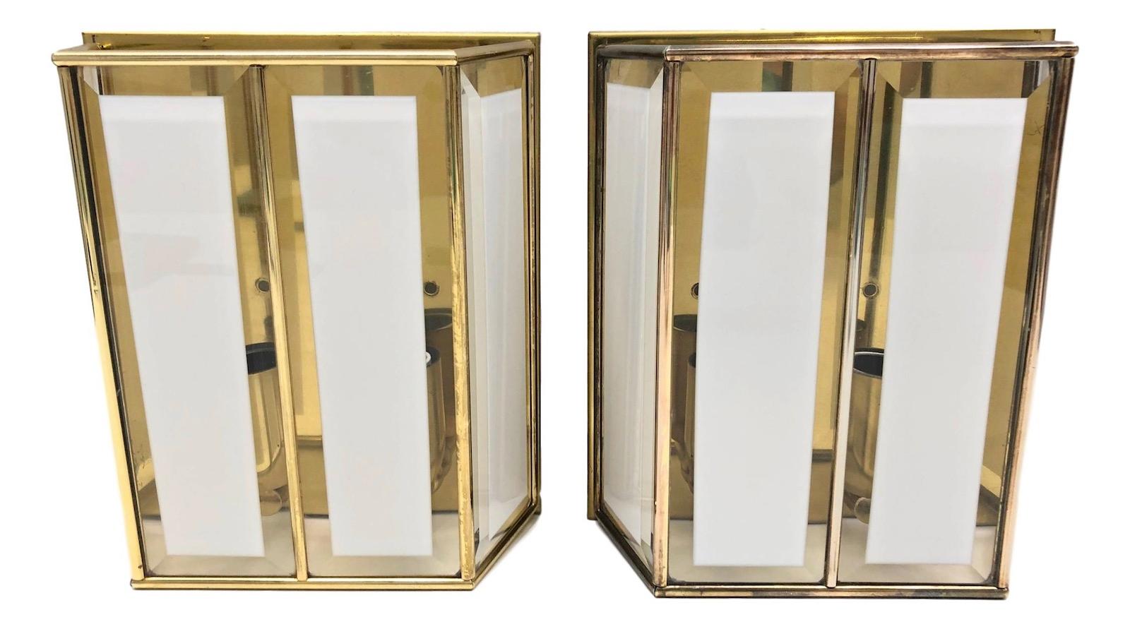 A stunning pair of modernist wall lights. Made of glass and brass. Easy to mount and fantastic to look at. Each fixture requires two European E14 / 110 Volt Candelabra bulbs, each bulb up to 40 watts.