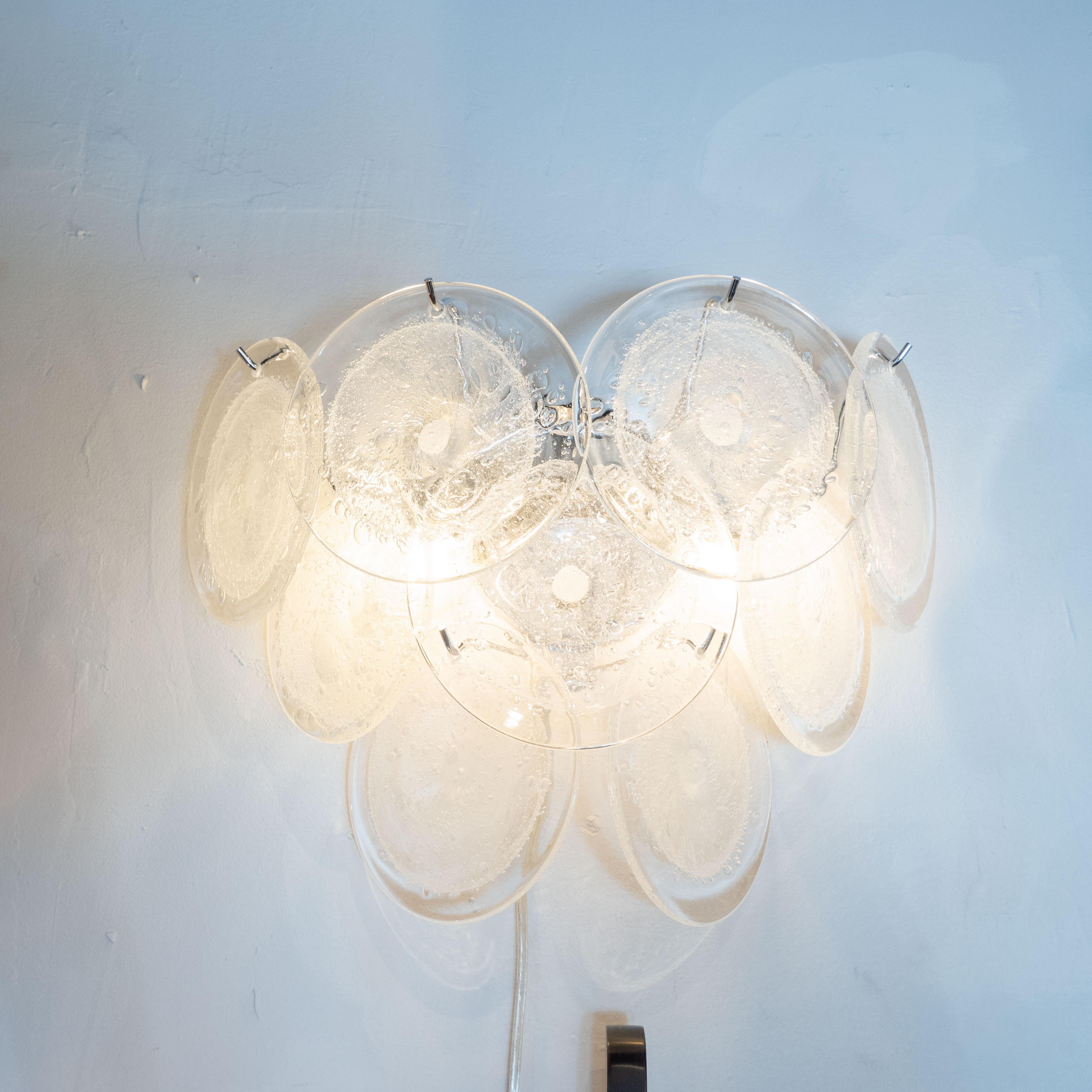 This beautiful pair of modernist 9-disc Vistosi sconces were made exclusively for high style deco by our atelier in Murano, Italy- the island off the coast of Venice, renowned for centuries for its superlative glass production. Realized in the