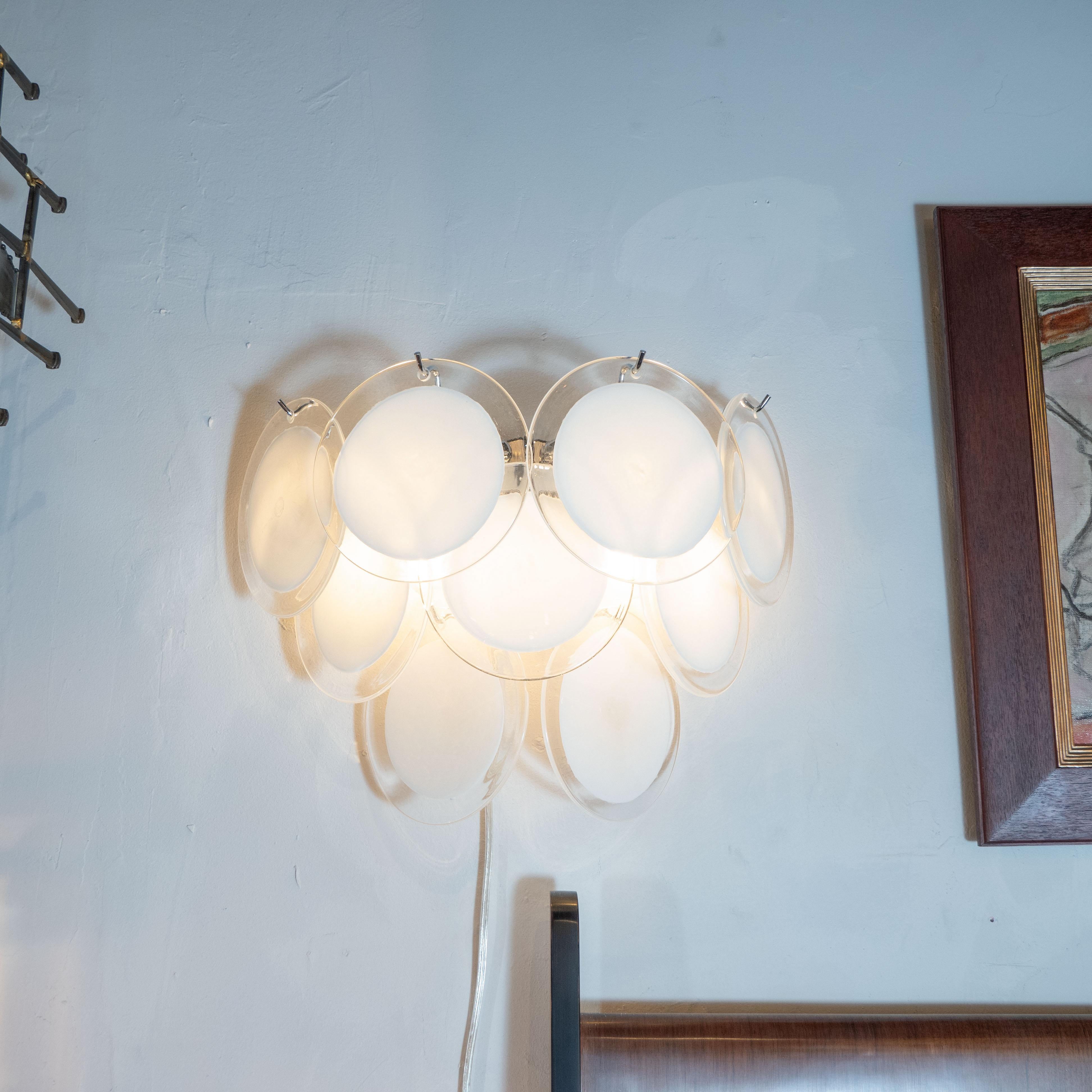 This beautiful pair of modernist 9-disc Vistosi sconces were made exclusively for high style deco by our atelier in Murano, Italy- the island off the coast of Venice, renowned for centuries for its superlative glass production. Realized in the