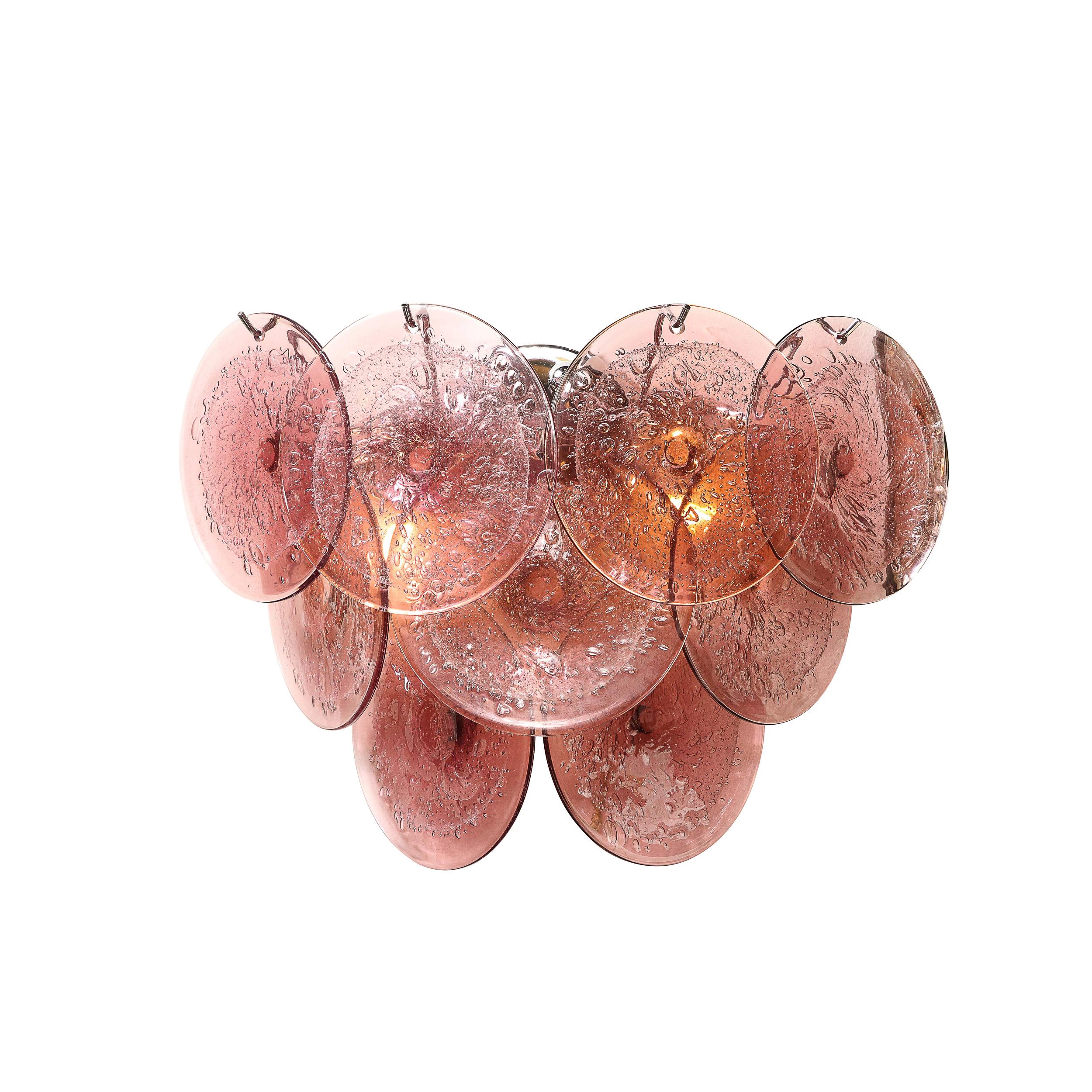 This elegant pair of modernist sconces were realized in Murano, Italy- the island off the coast of Venice renowned for centuries for its superlative glass production. They feature nine discs each suspended from a lustrous polished chrome frame. Each