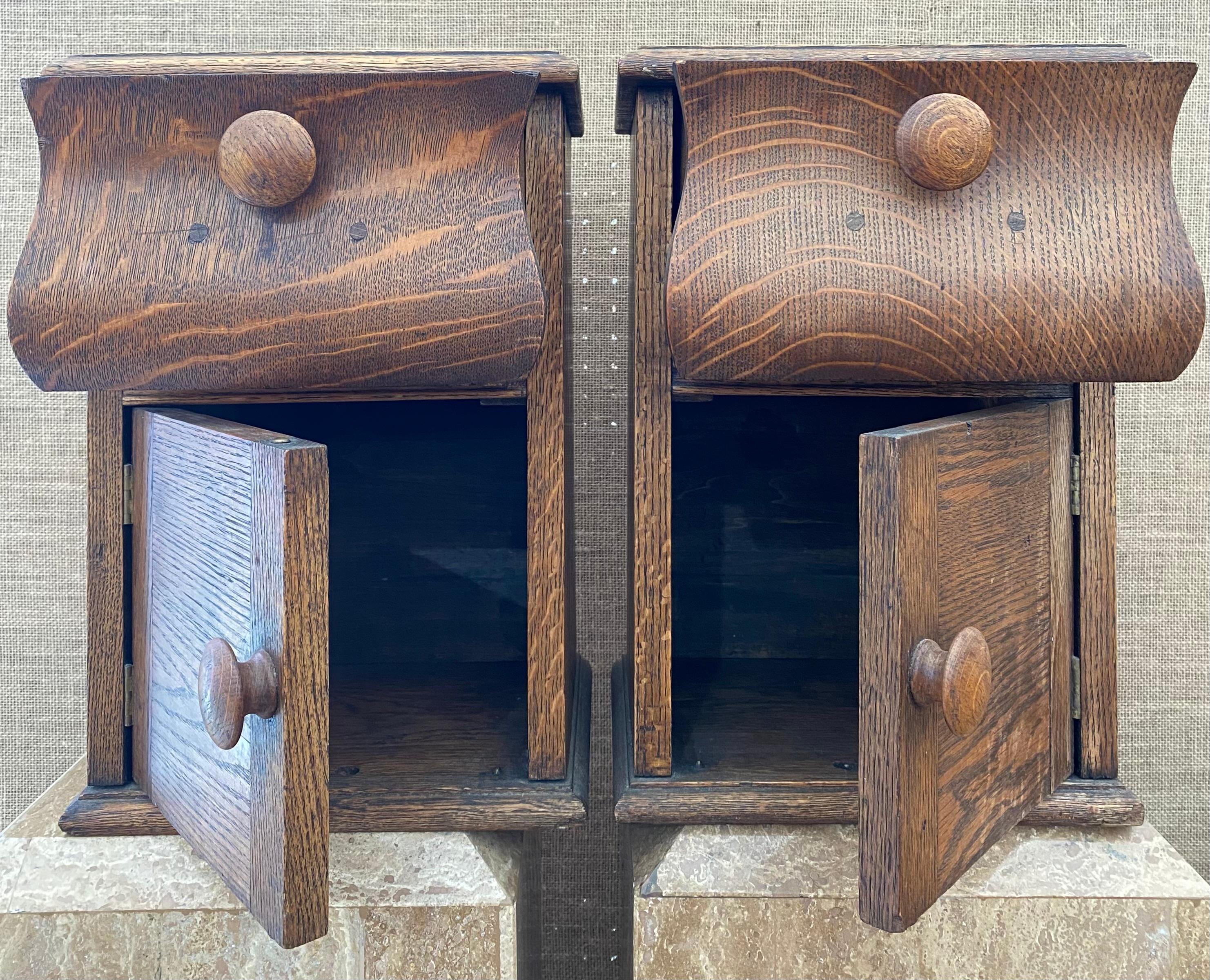 Sculptural small cabinets carved from Tiger Oak. Smoothly openable drawers above cabinet space with original turned knobs. Lovely patina; recently oiled. Excellent condition for age. Unknown provenance; sourced in the Colorado Rocky Mountains.
