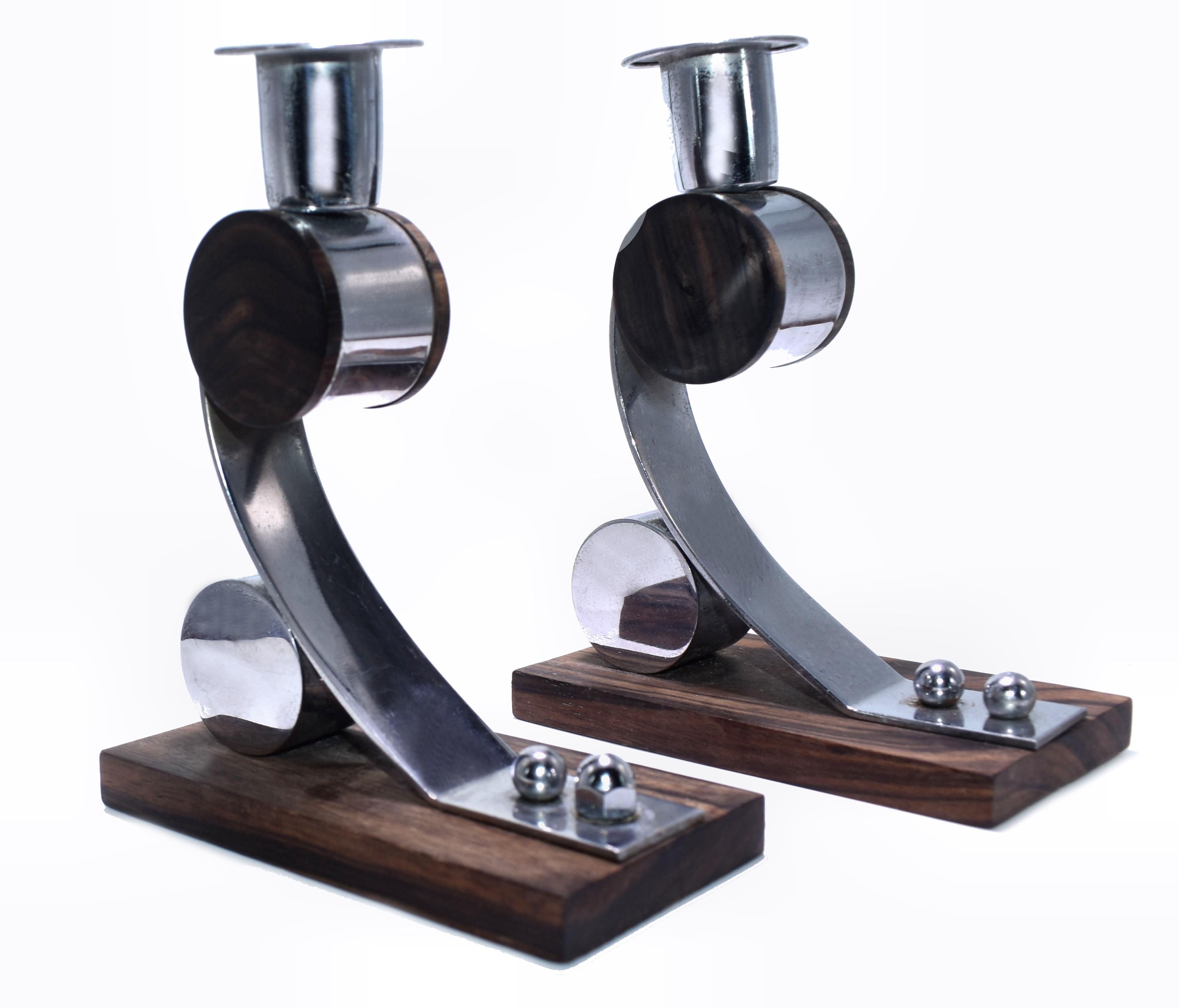 Modernist original Art Deco pair of matching candlesticks dating to the 1930s and originating from France. Made from chrome and Macassar ebony, beautiful and well crafted design.