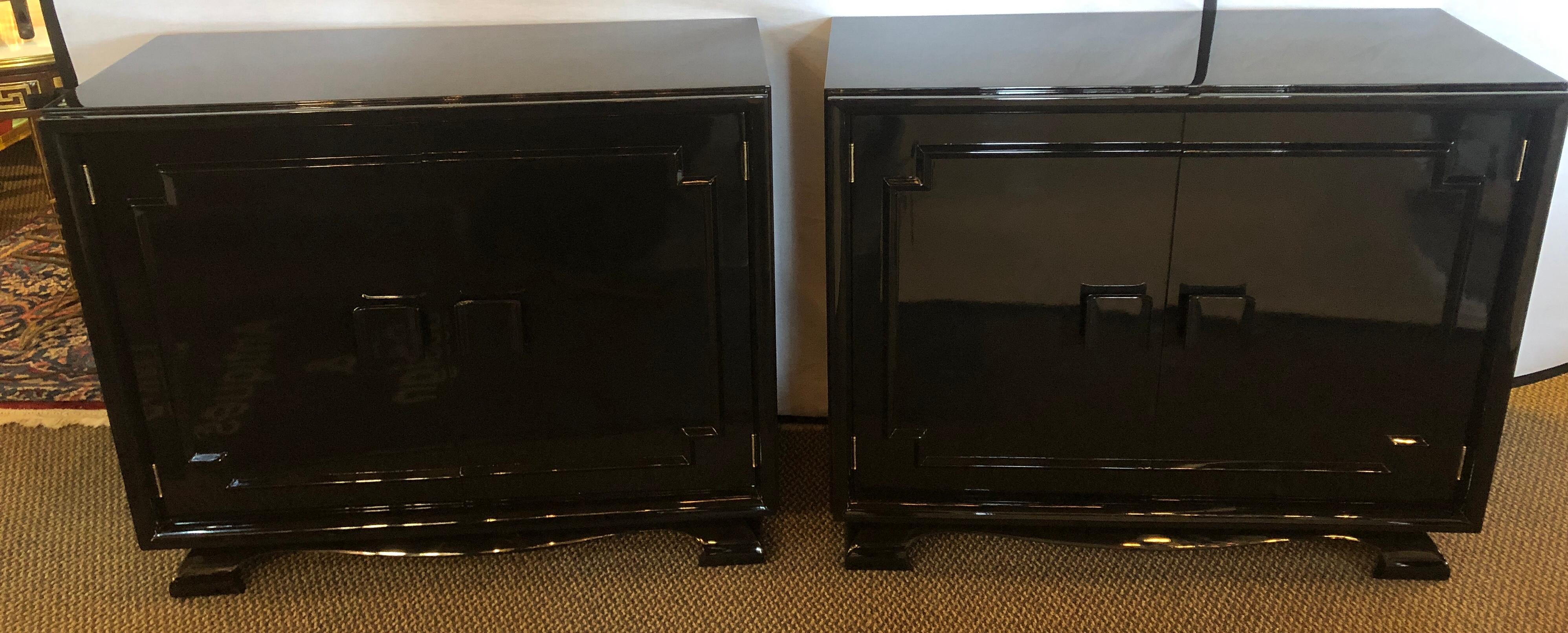 Pair of modernist Asian inspired ebony bachelor chests in James Mont Style. This Fine recently Lacquered pair of Mid-Century Modern chests or nightstand are simply stunning and the photographs do the actual pieces no justice whatsoever. The