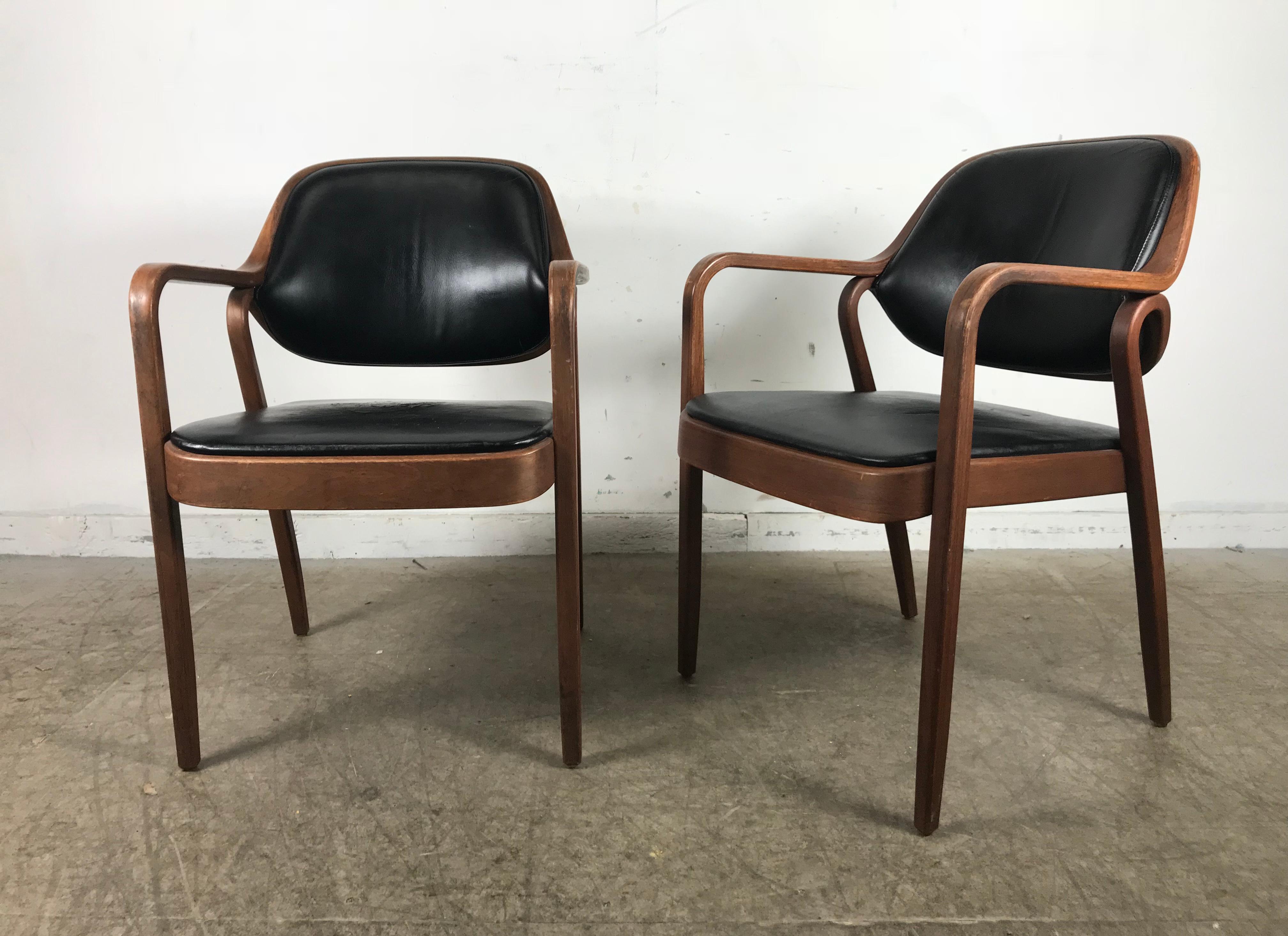Pair of modernist bentwood mahogany and leather chairs by Don Pettit for Knoll, nice original condition. Minor wear and crazing to original black leather seat and back. Retain original early KNOLL labels.