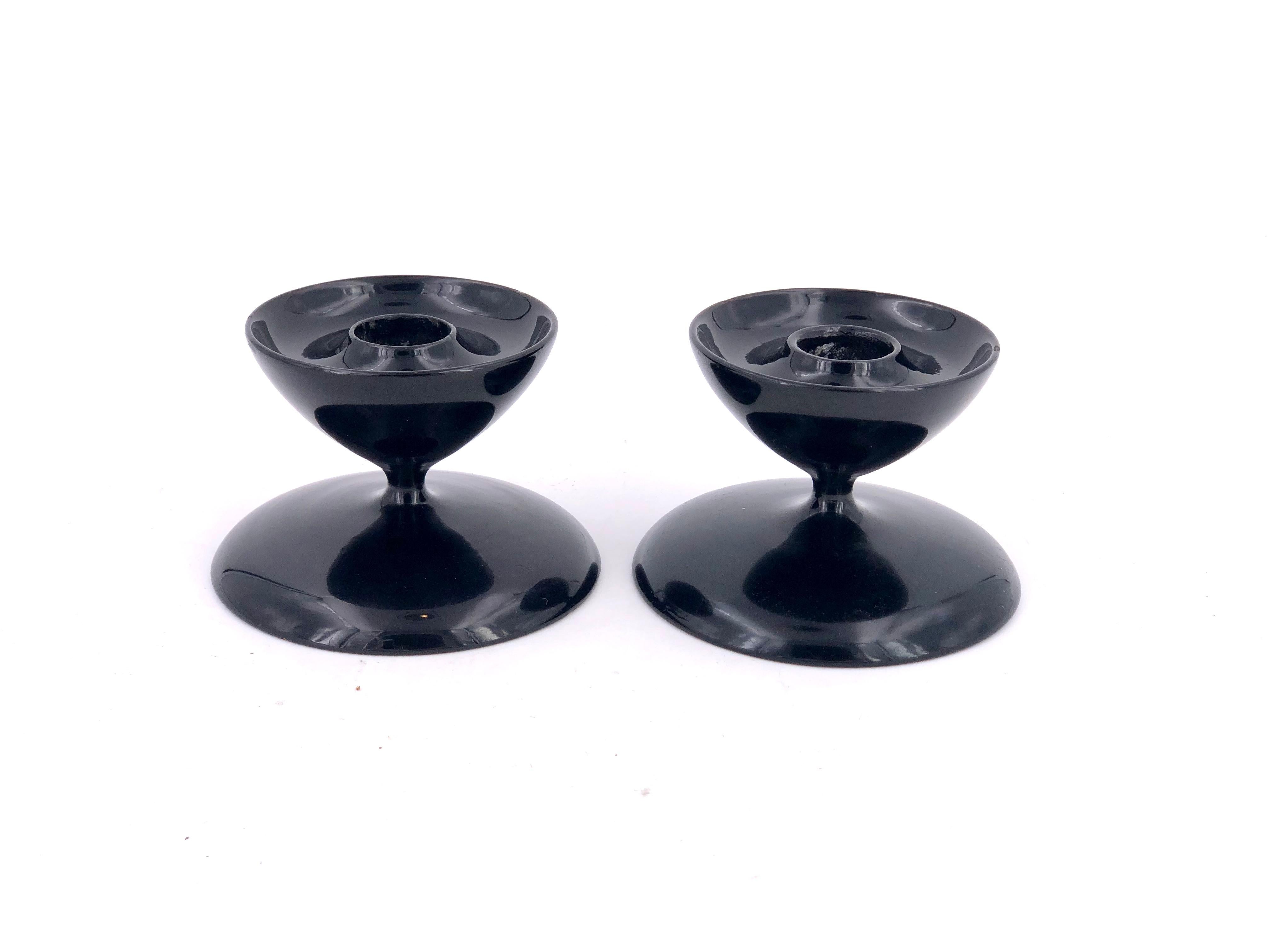 Beautiful pair of Japanese Mid-Century Modern, black lacquer wood candleholders circa 1950s in a glossy finish and very nice condition retains old label. Each candleholder has an open for 1