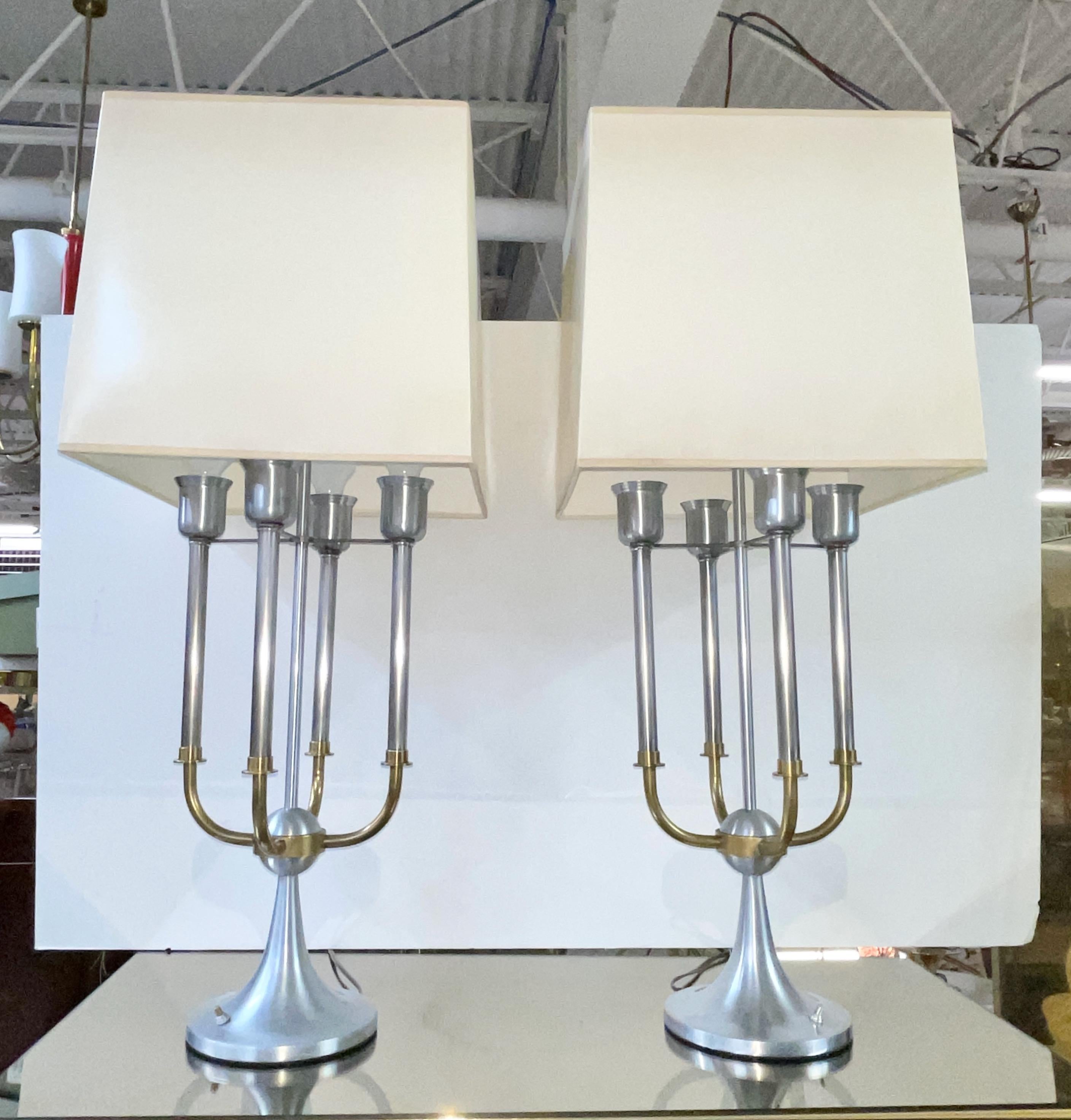 Very well crafted pair of modernist bouillotte lamps in brushed nickel and solid brass, each with four light candelabra, with brass arms extending from a central orb atop a round flared tulip base and an elongated stem reaching 33.5 inches high to a