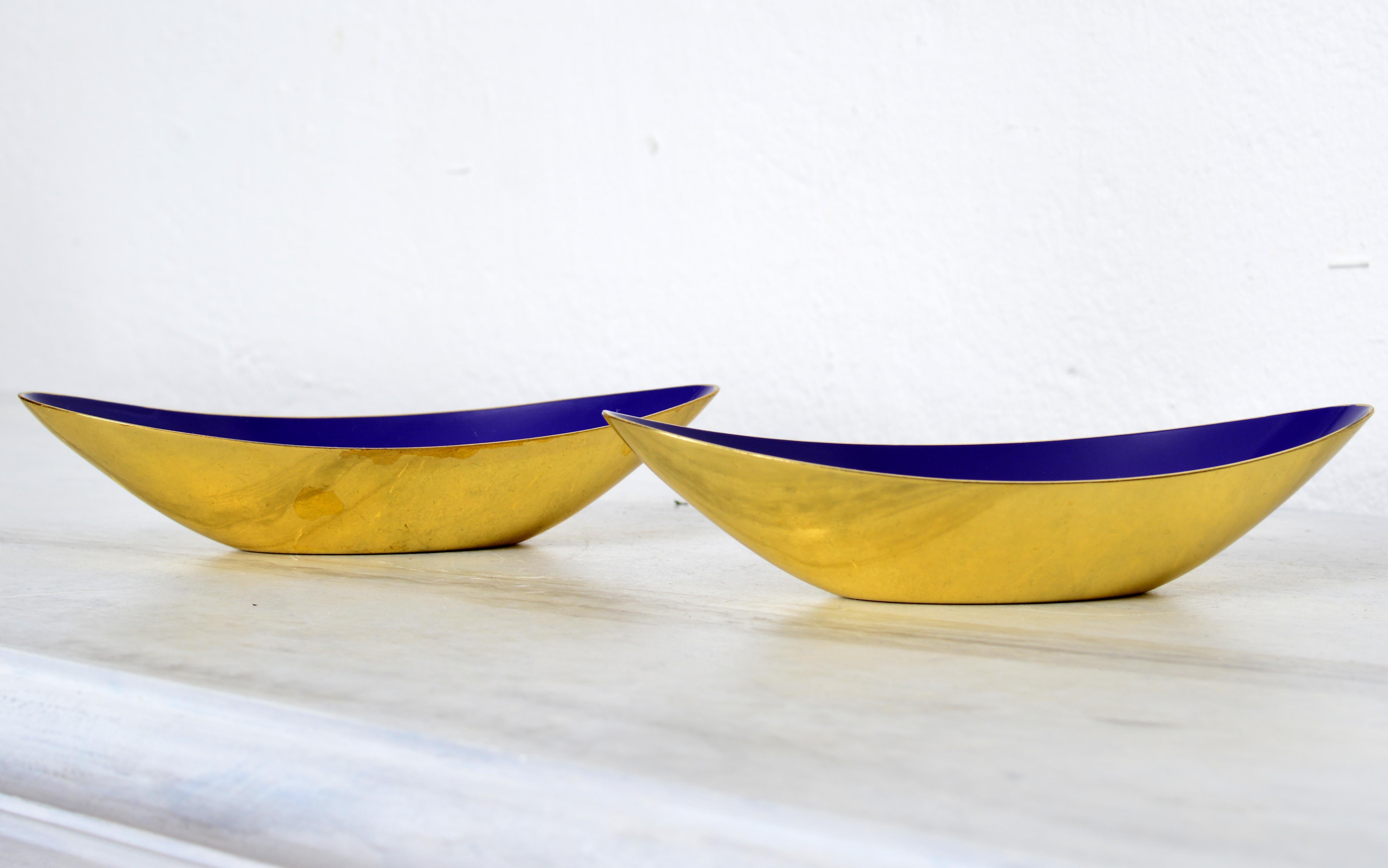 A pair of Swedish bowls by Gunnar Ander, brass and beautiful deep blue enamel inside. 
Produced by Ystad-Metall, located in the town of Ystad in Sweden. Very elegant oval modernist bowl. Signed with the Ystad Metall logotype and the stylized