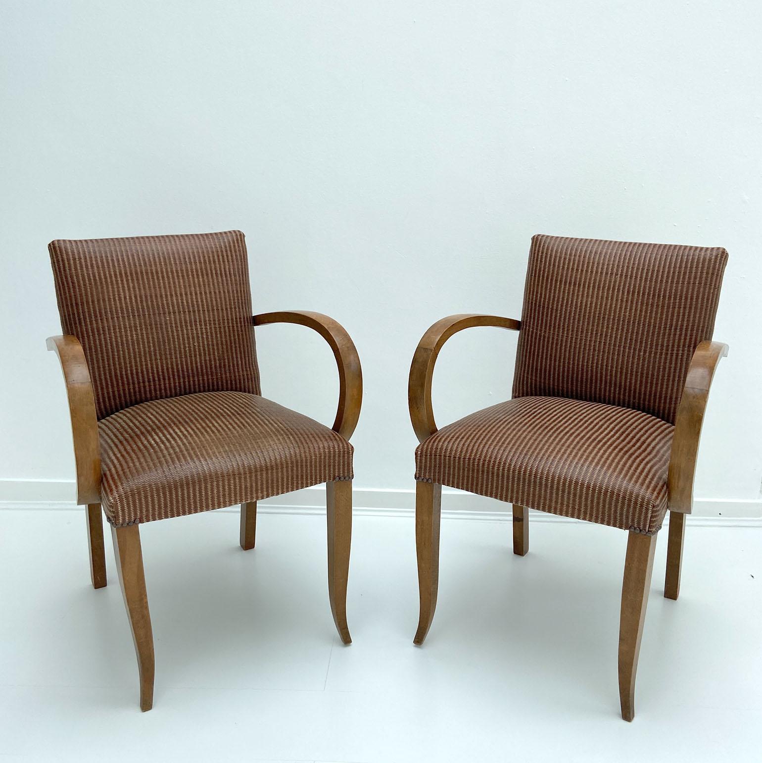 Pair of Art Deco 1930s French armchairs or bridge chairs. The modernist chairs have clean lines and elegant curved front legs in oak. The arms are in bentwood. They have been reupholstered in early 21st Century tobacco brown leather and linen woven